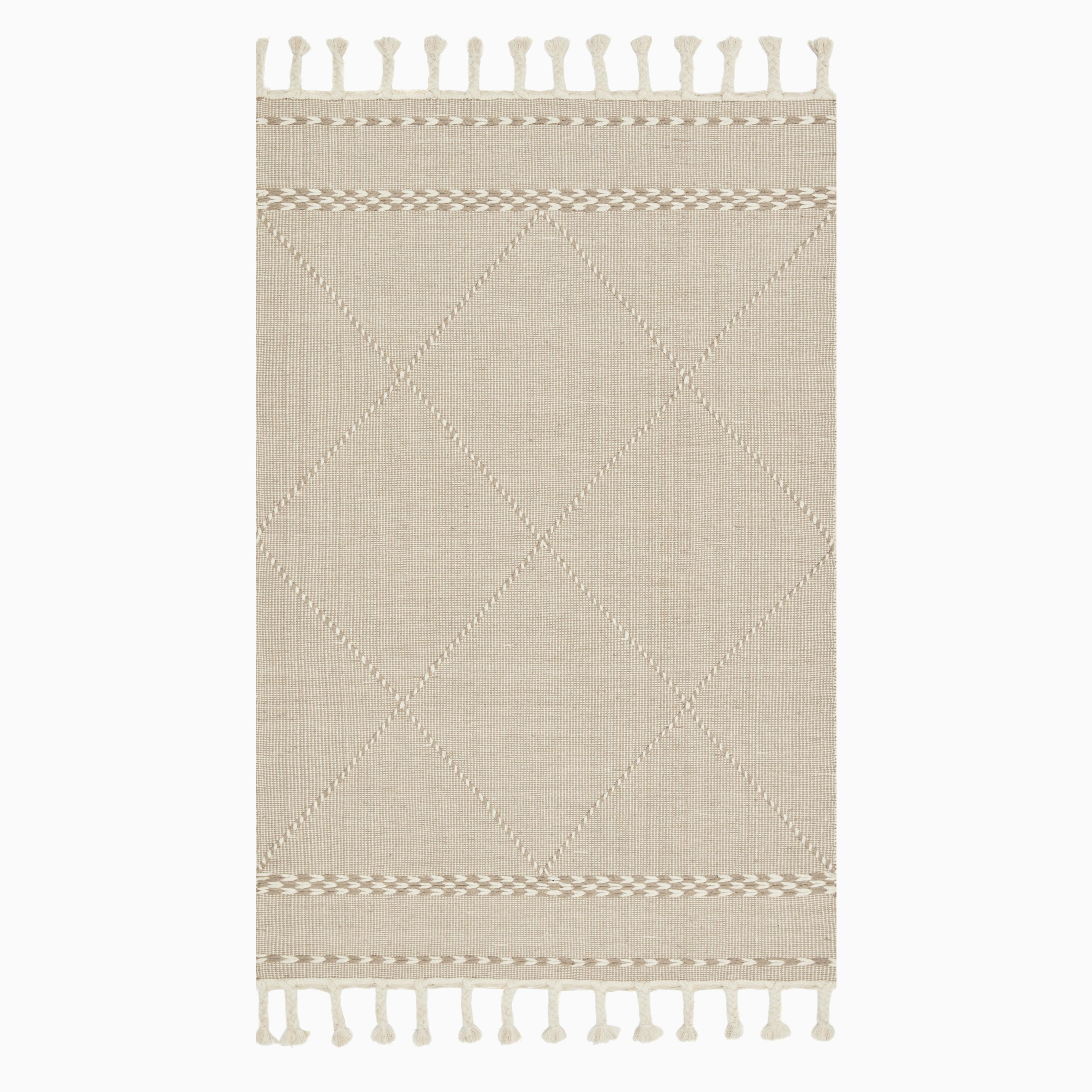 Hand loomed beige wool rug with a subtle diamond pattern and braided accents, finished with decorative fringe.