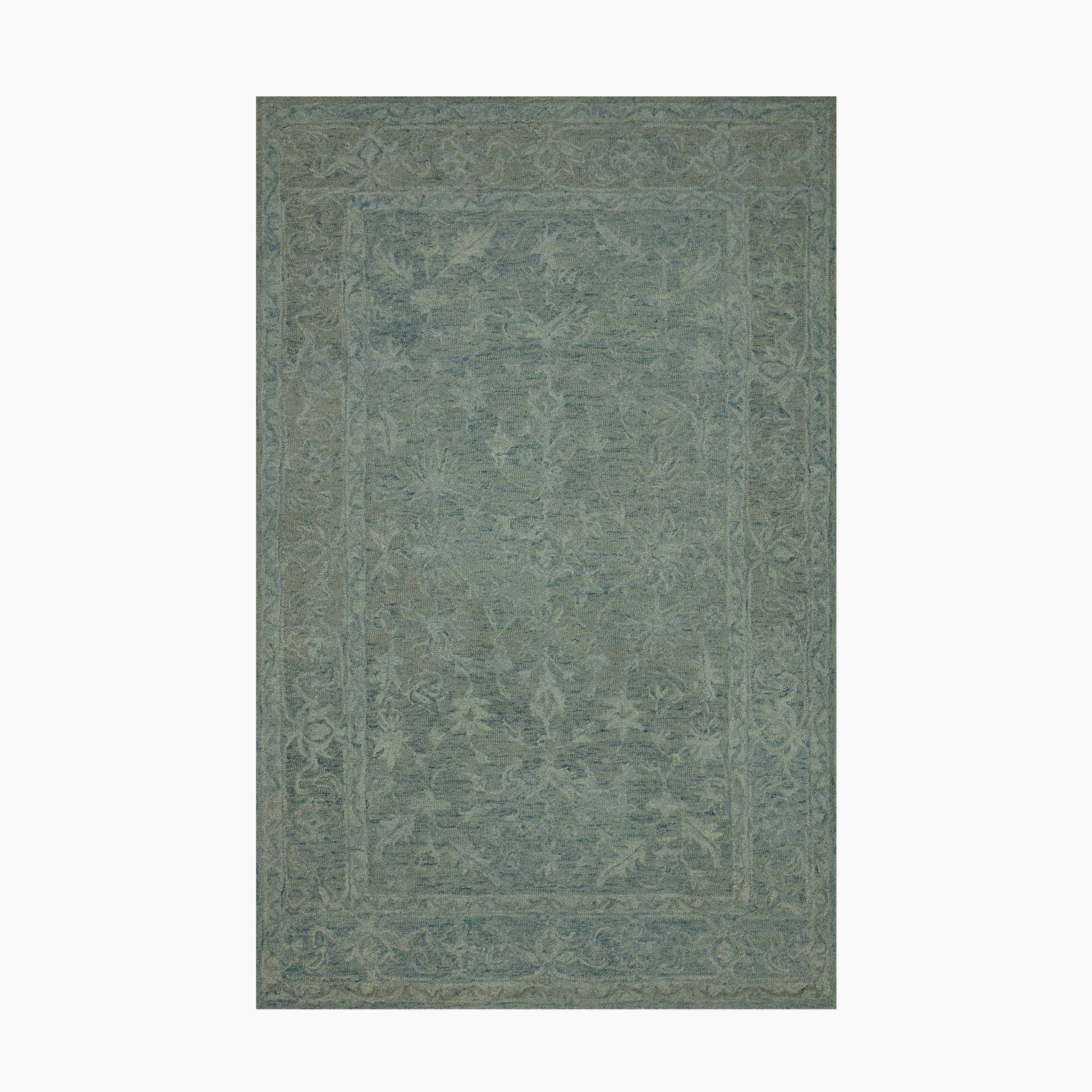 Hooked wool rug in deep forest green, featuring a tonal border design that adds texture and durability to transitional spaces.