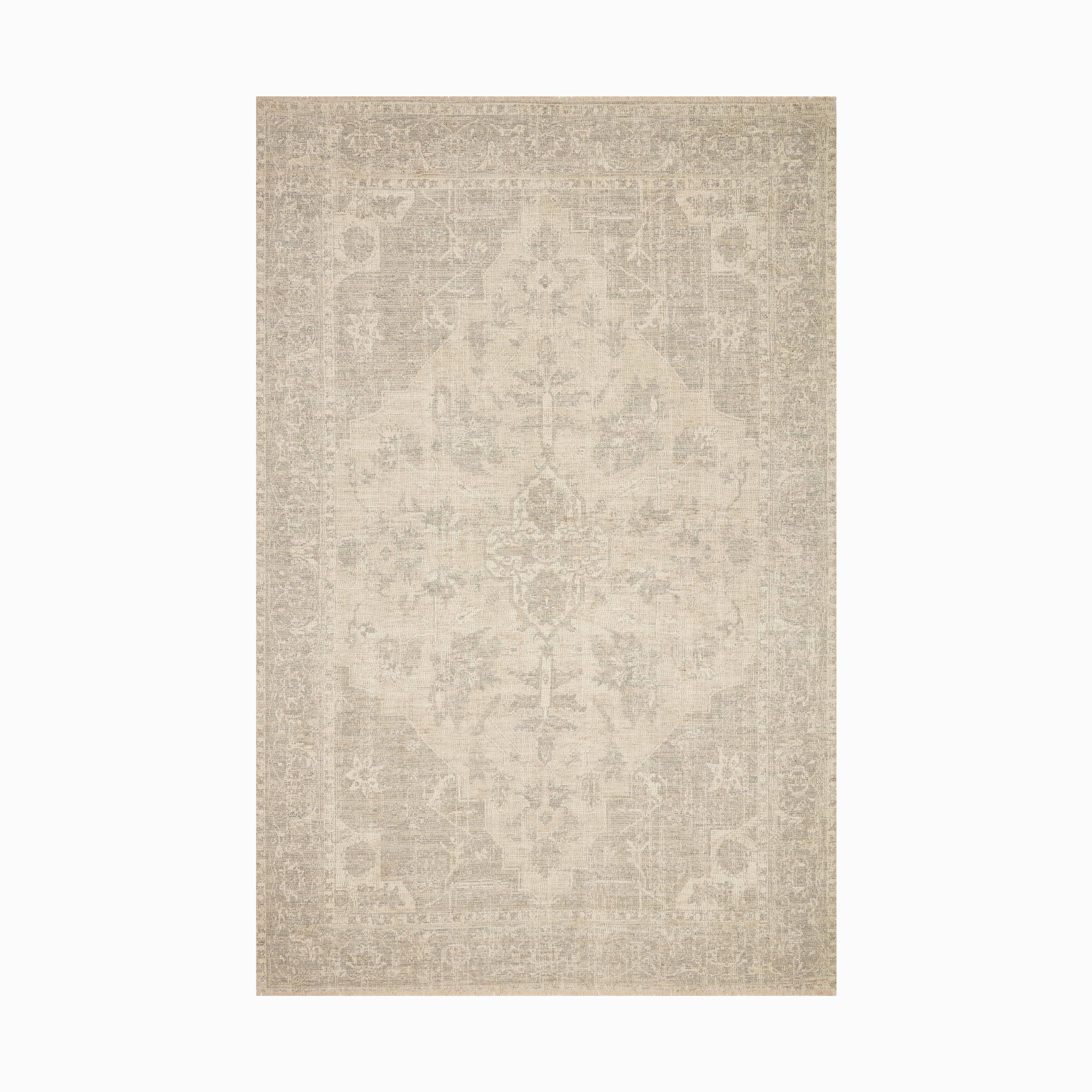 Polyester-cotton blend rug in warm cream with faded ocean blue details, hand-woven for a durable yet elegant texture in a transitional style.