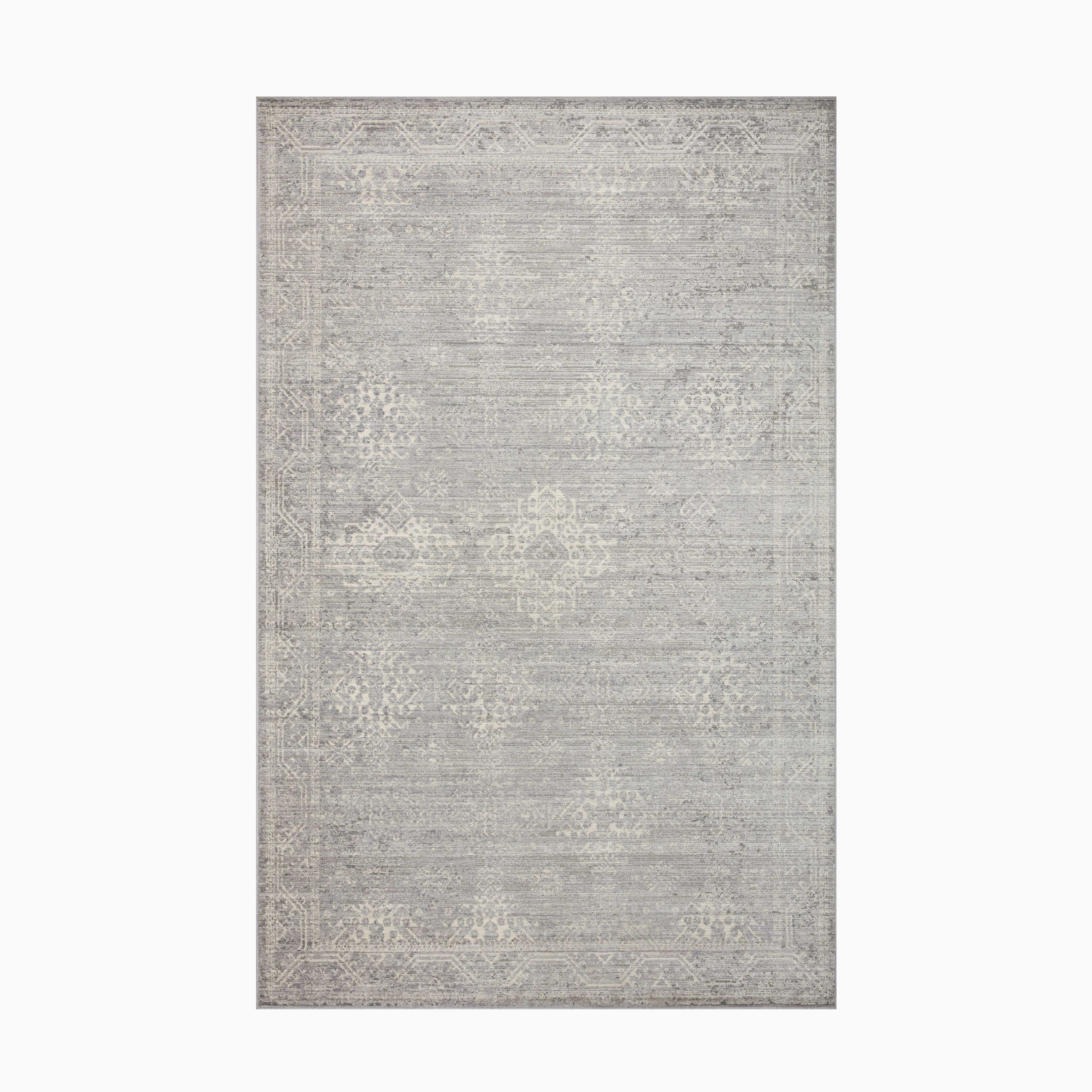 A contemporary polyester-polypropylene rug in misty gray and pearl white, designed with a power-loomed construction for lasting durability.