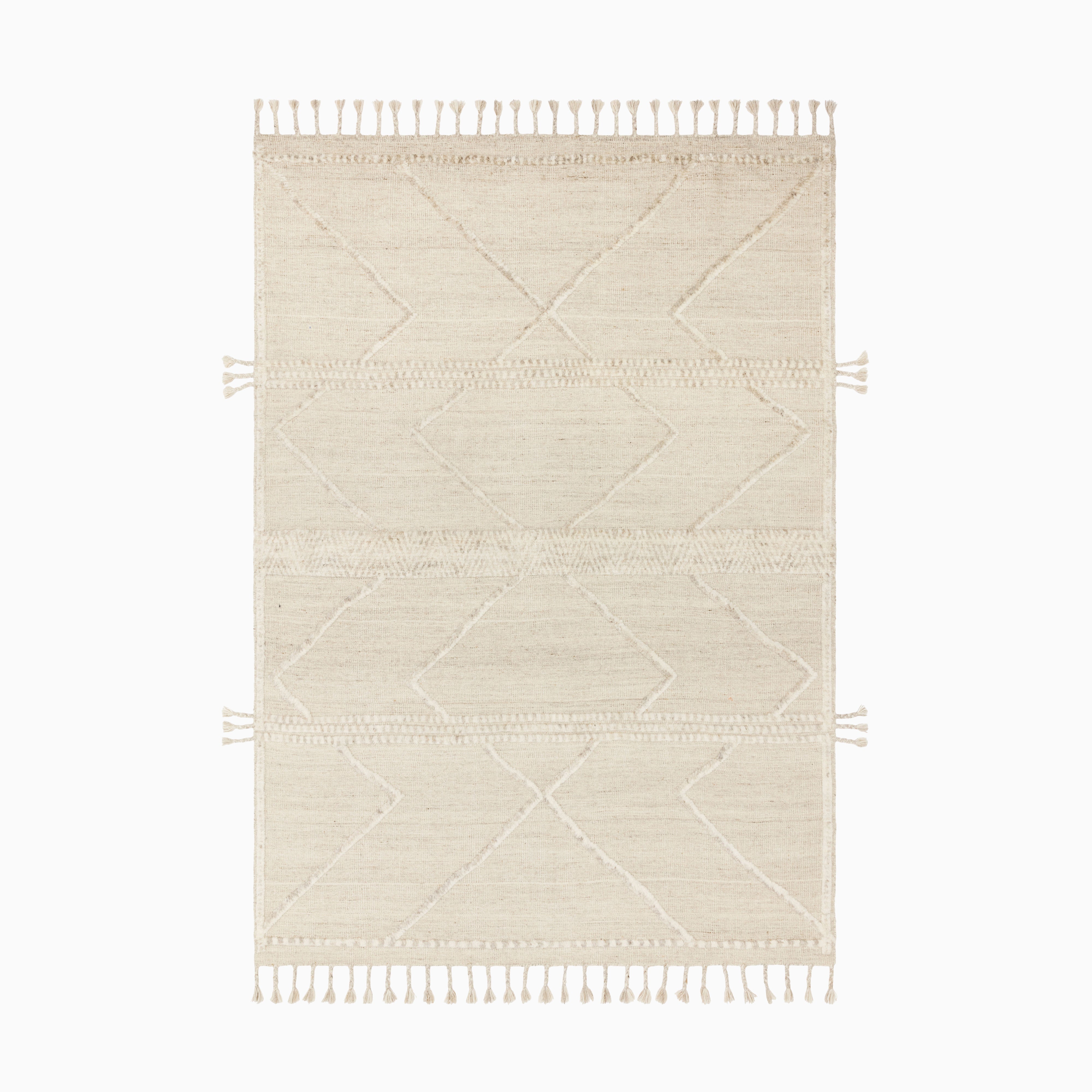 Contemporary wool blend rug in a soft natural and cream palette, hand-knotted with intricate geometric motifs and tasseled edges.