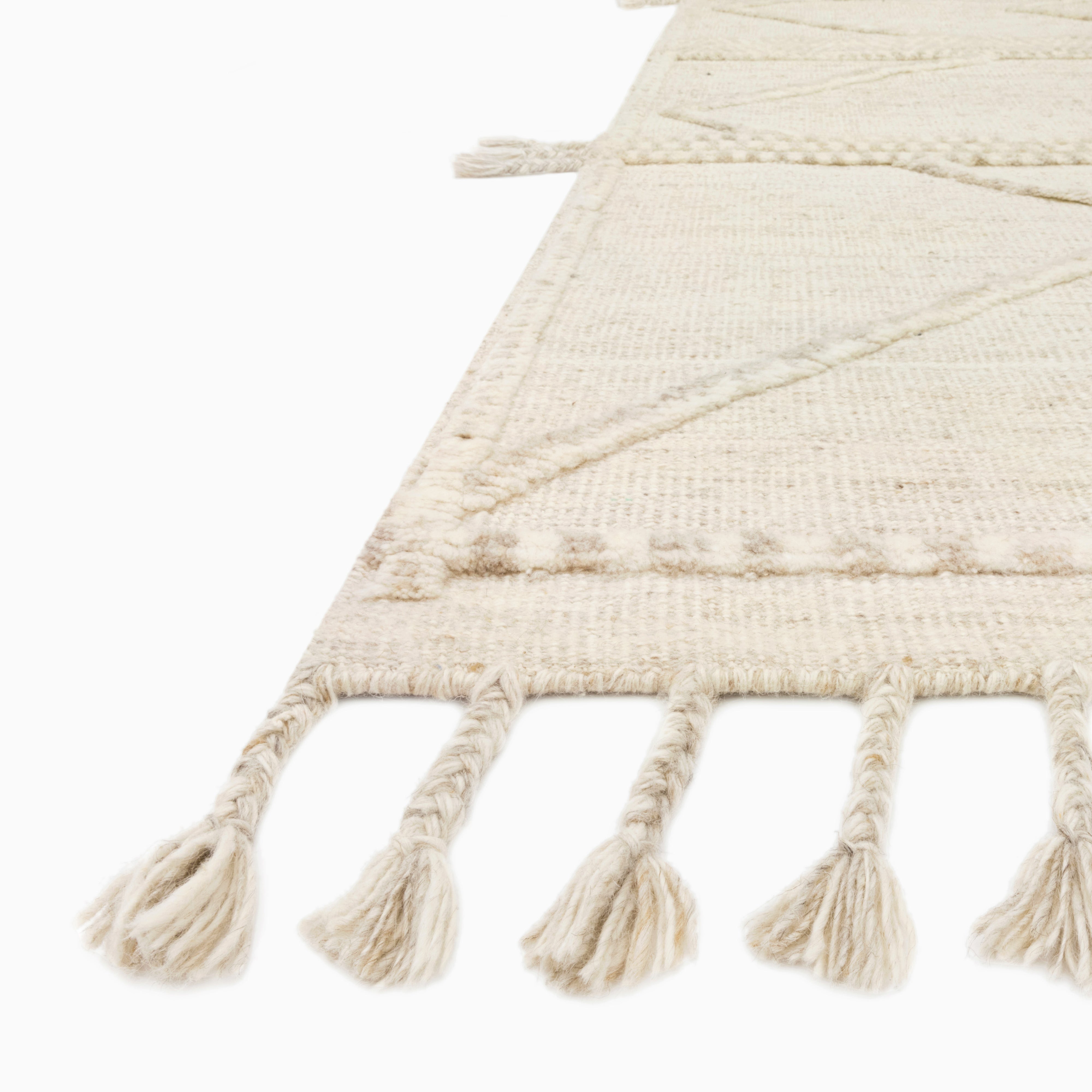 Micah Wool Blend Rug in Natural / Cream, blending soft neutral tones with a minimalist geometric design and fringe accents, great for relaxed decor.