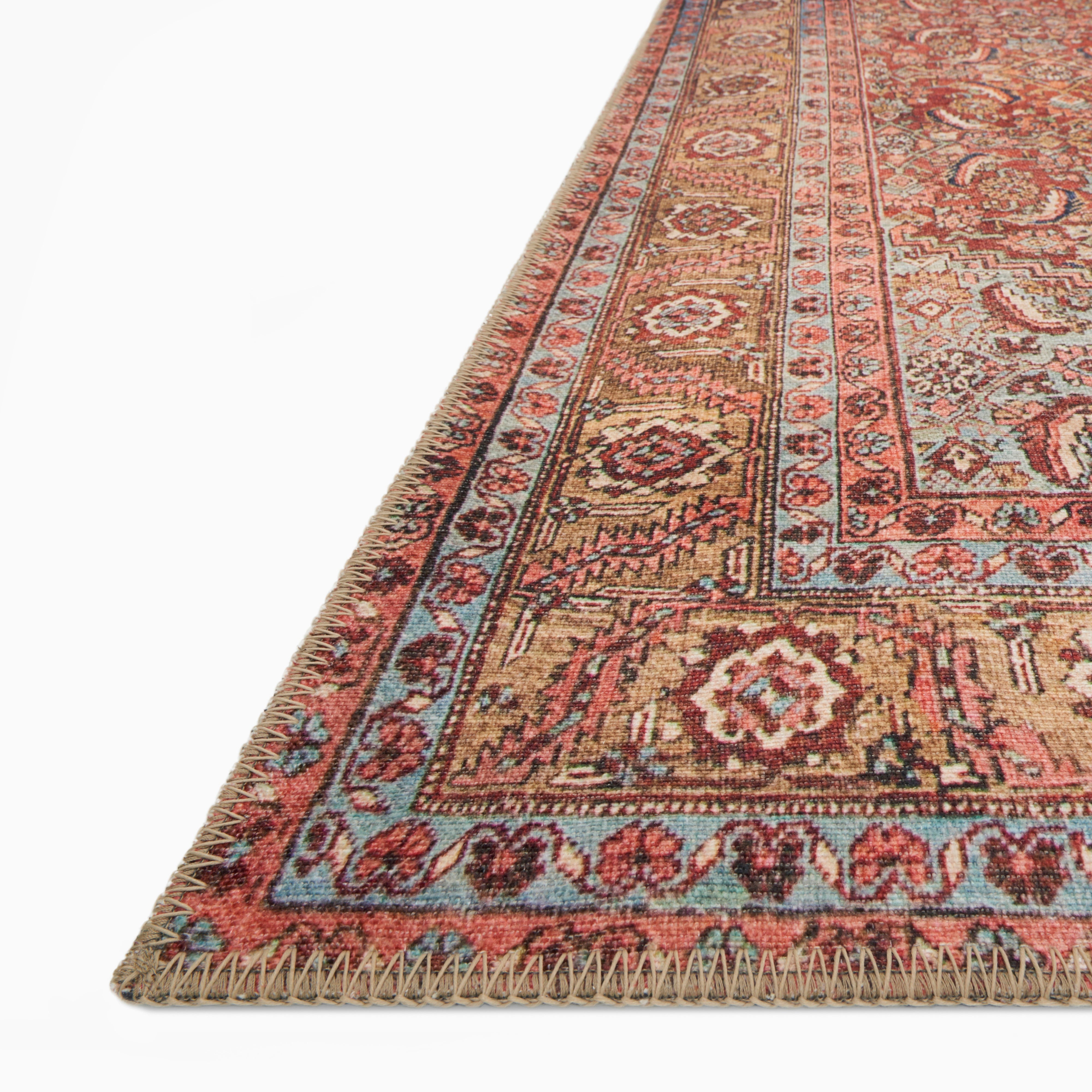 Pascal Polyester Face Rug in Brick / Multi with a deep red base, beige medallion, and accents of blue, gold, and brown in an intricate floral pattern.
