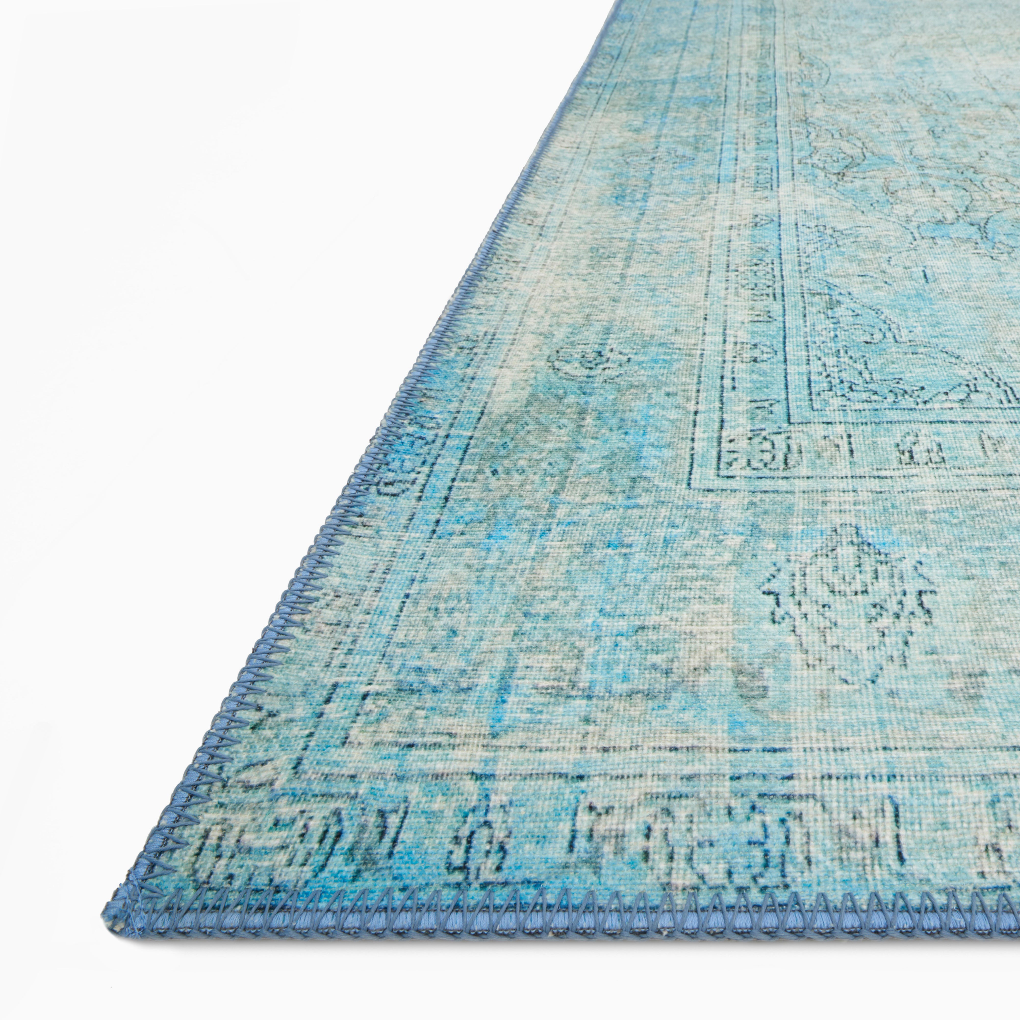 Pascal Polyester Face Rug in Lake with a faded turquoise base and sky blue detailing, creating a vintage-inspired distressed look.