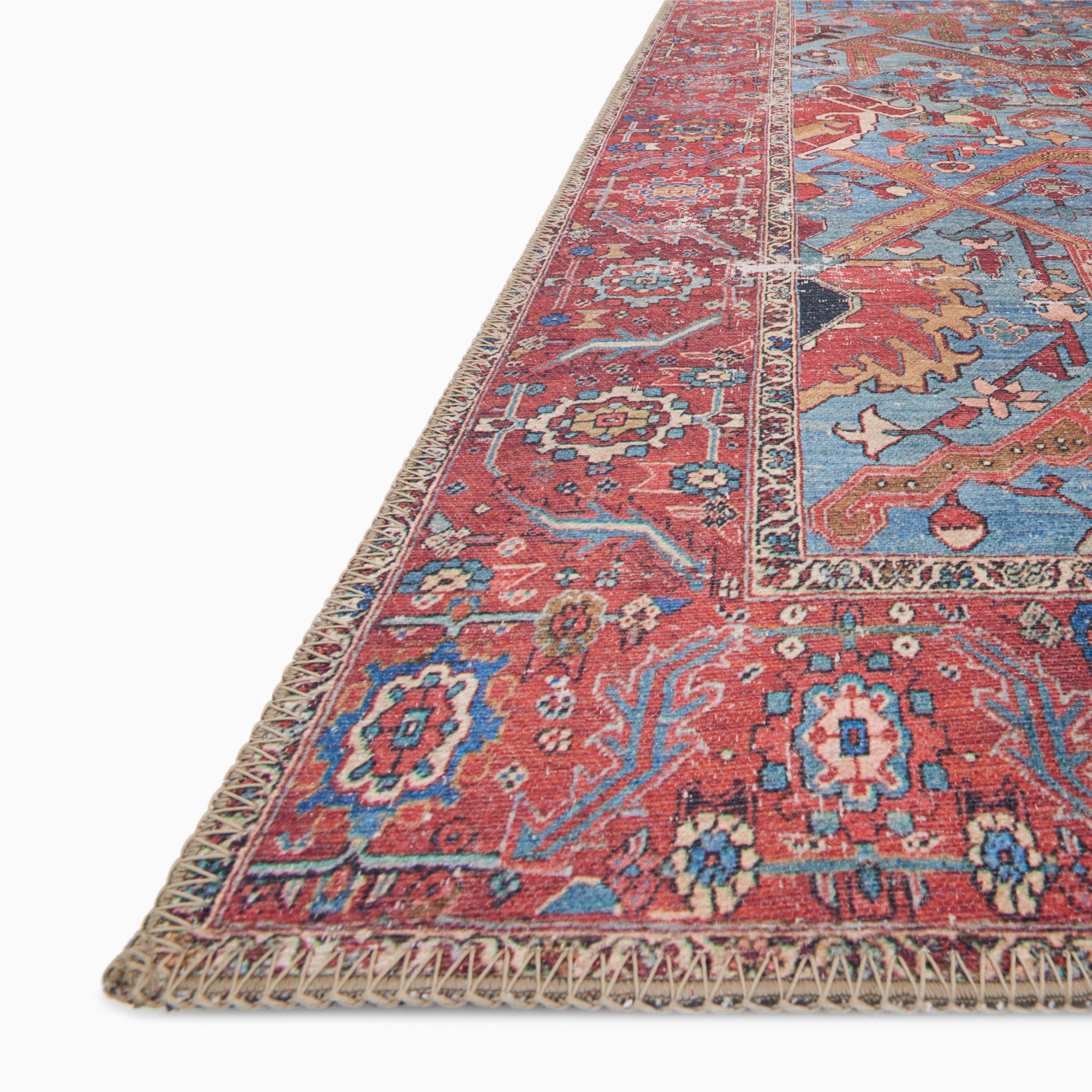 Pascal Polyester Face Rug in Rouge / Lake featuring a distressed cobalt blue and burgundy pattern with gold and ivory floral accents.