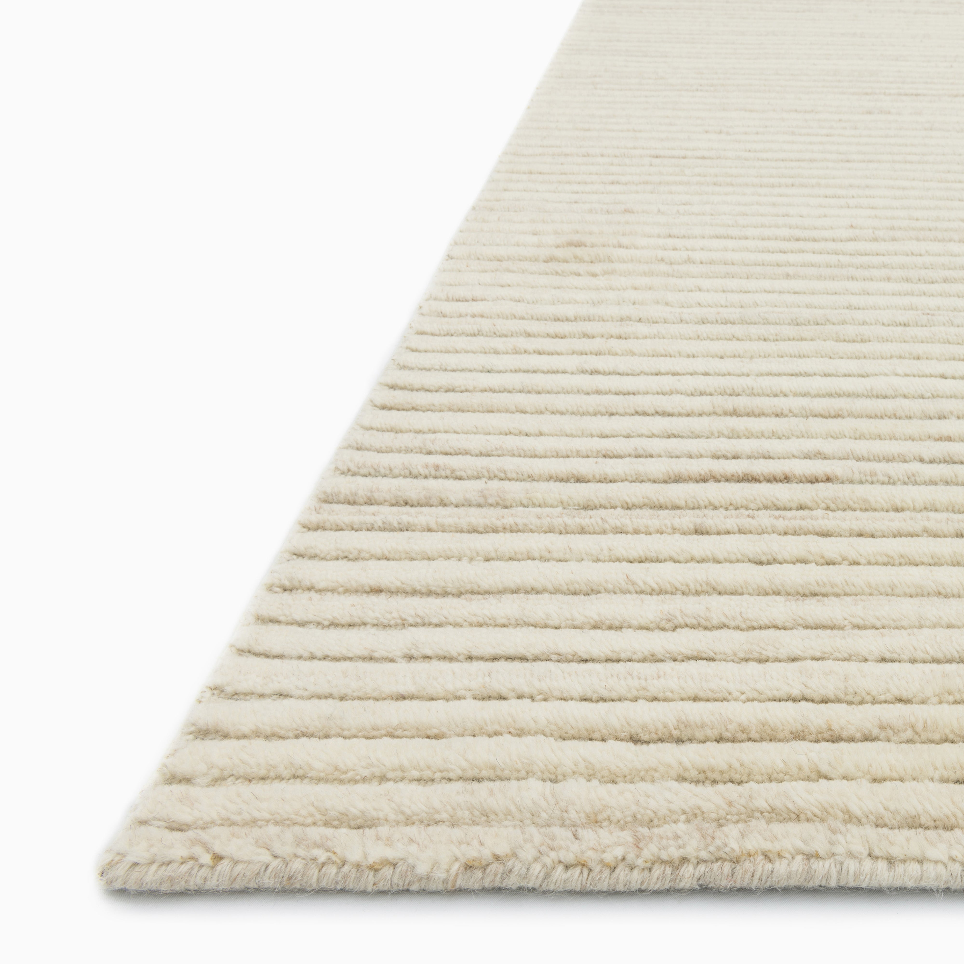 Quinton Wool Blend Rug in Cream, blending light beige and white hues in a textured weave, ideal for a cozy and neutral setting.