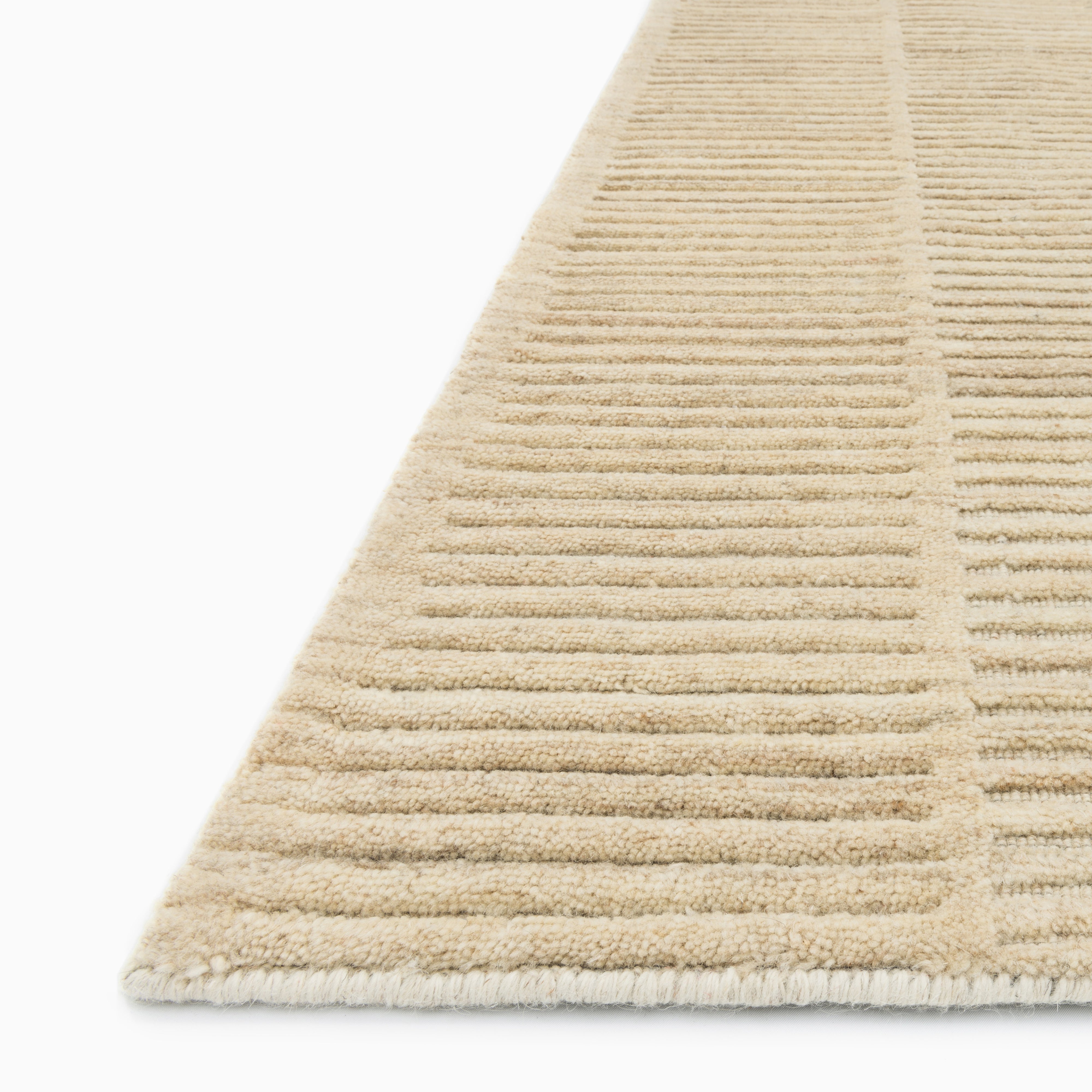 Quinton Wool Blend Rug in Sand, featuring a soft beige tone with a subtle textured weave, perfect for a neutral and inviting space.