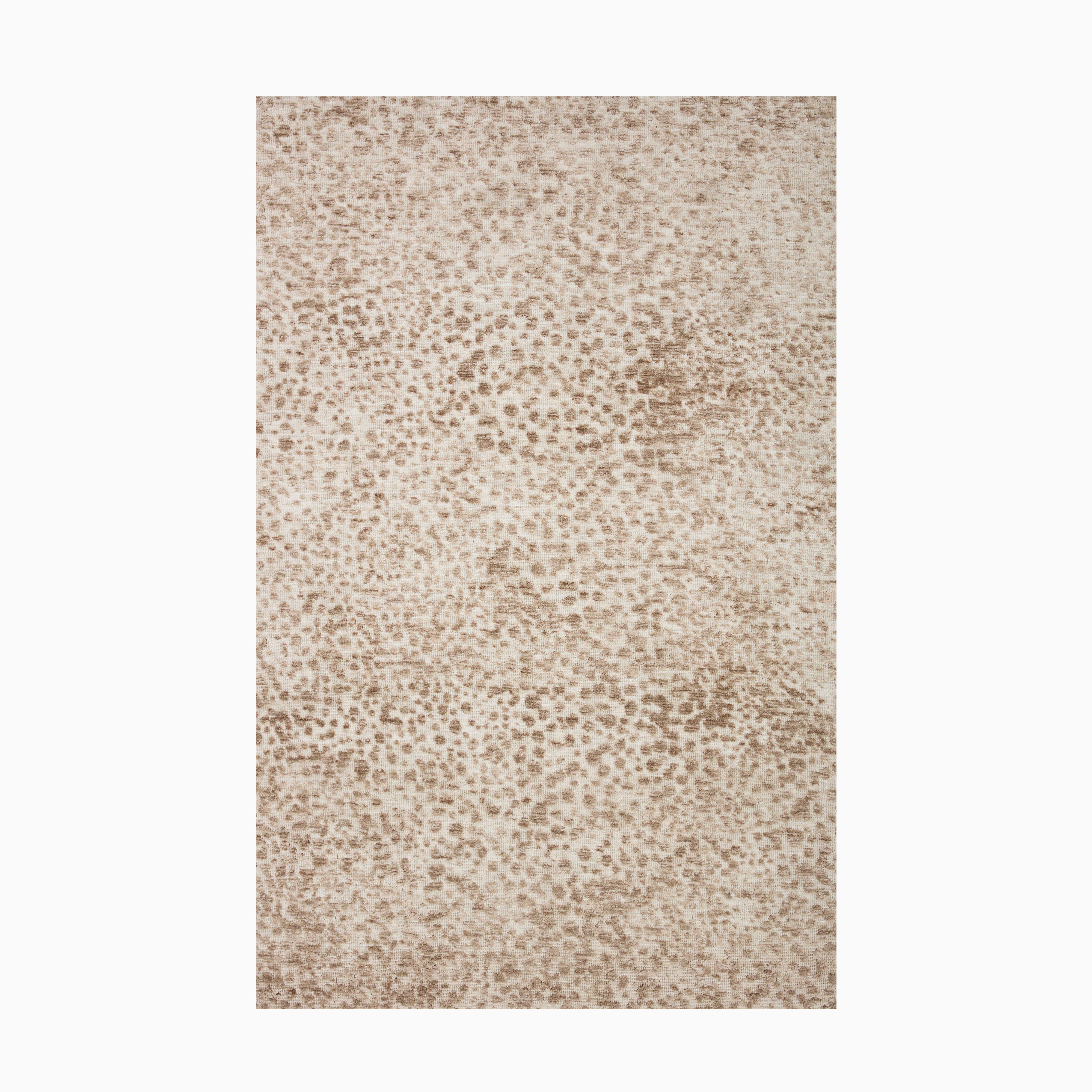 Transitional polyester pile rug in cream and rust, crafted with a power-loomed technique for lasting durability and a soft, textured surface.