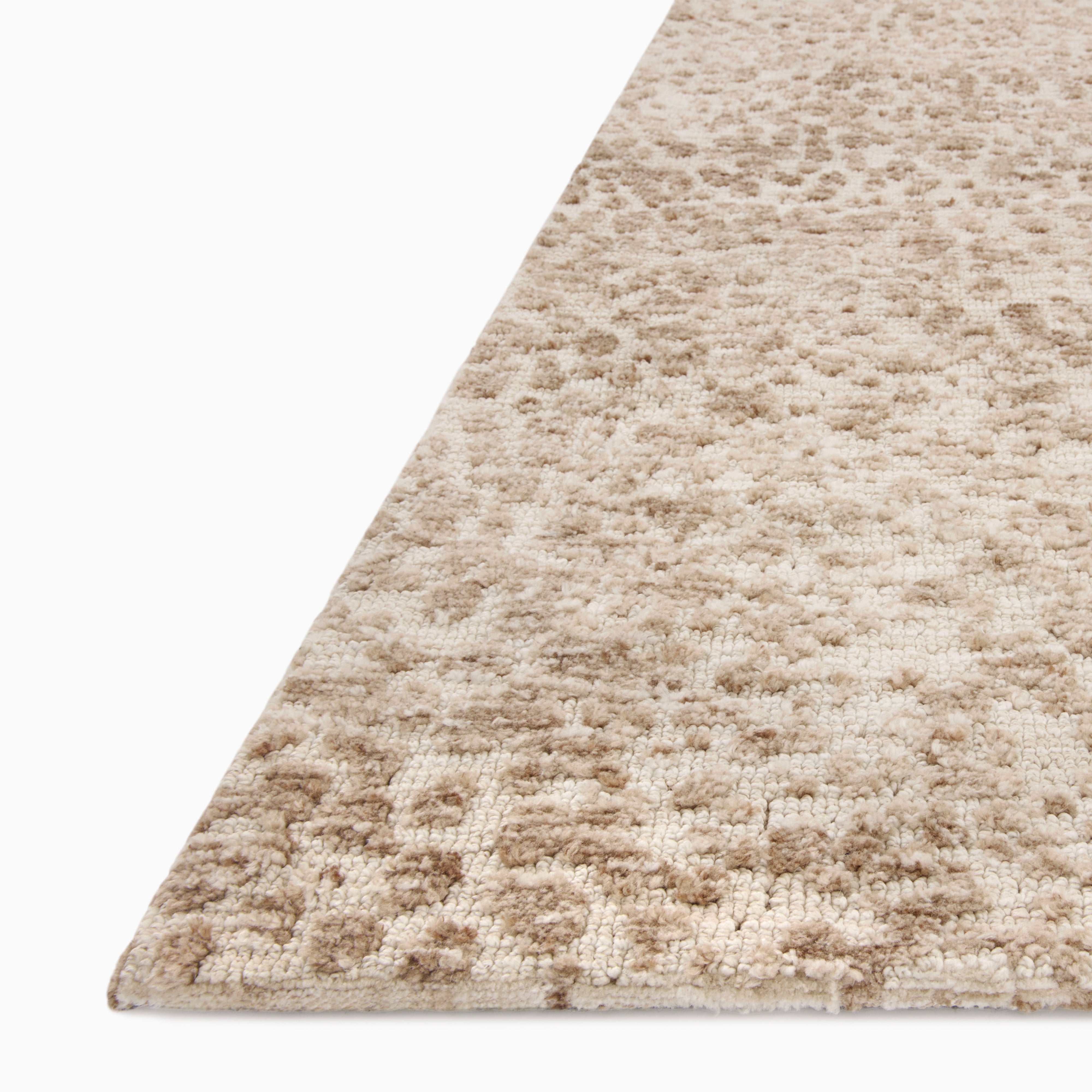 Rollins Polyester Pile Rug in Cream and Rust, featuring a soft beige base with scattered warm brown and burnt orange accents for a textured, organic look.