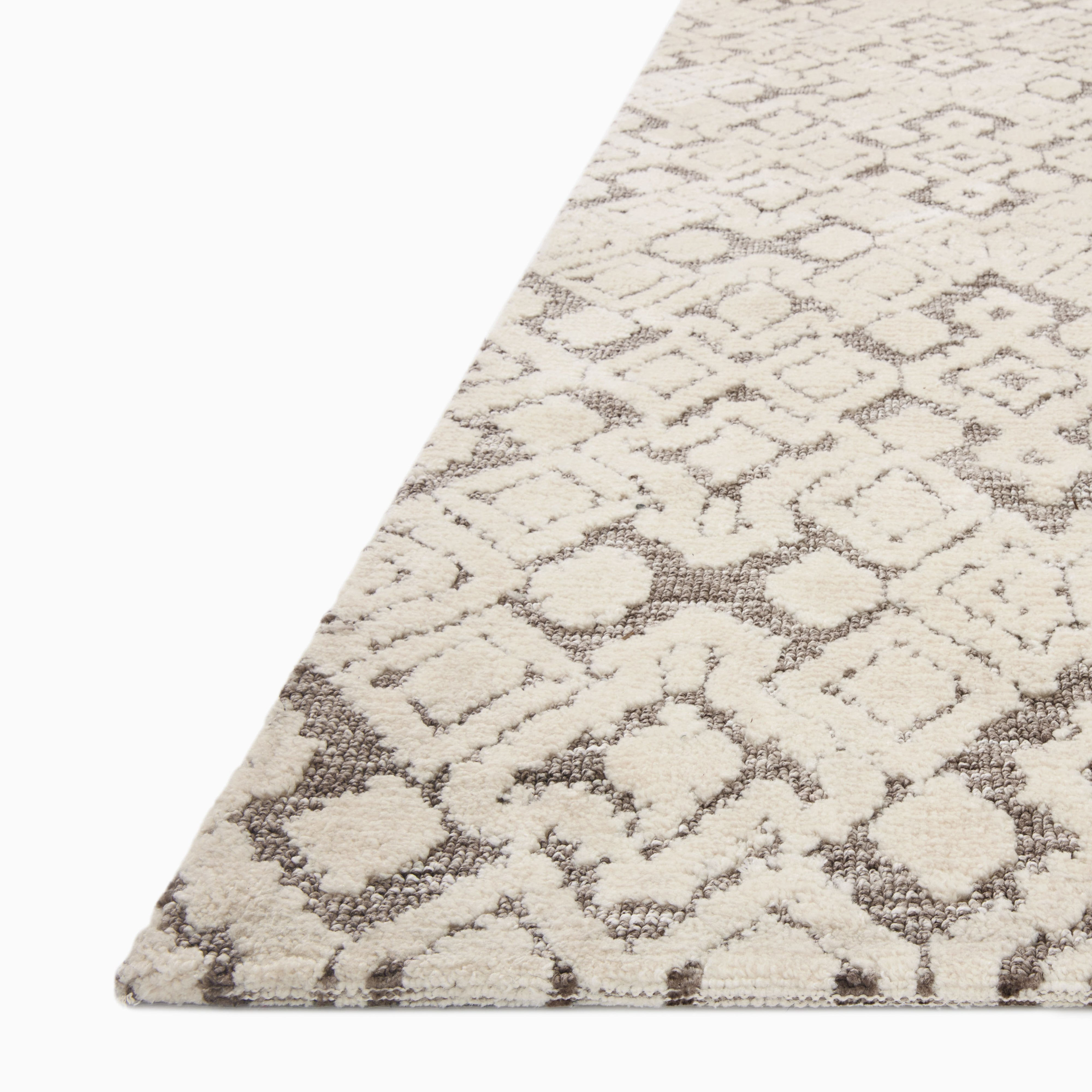 Rollins Polyester Pile Rug in Cream and Smoke, showcasing a neutral beige-toned foundation with dark gray diamond accents for a modern, patterned finish.