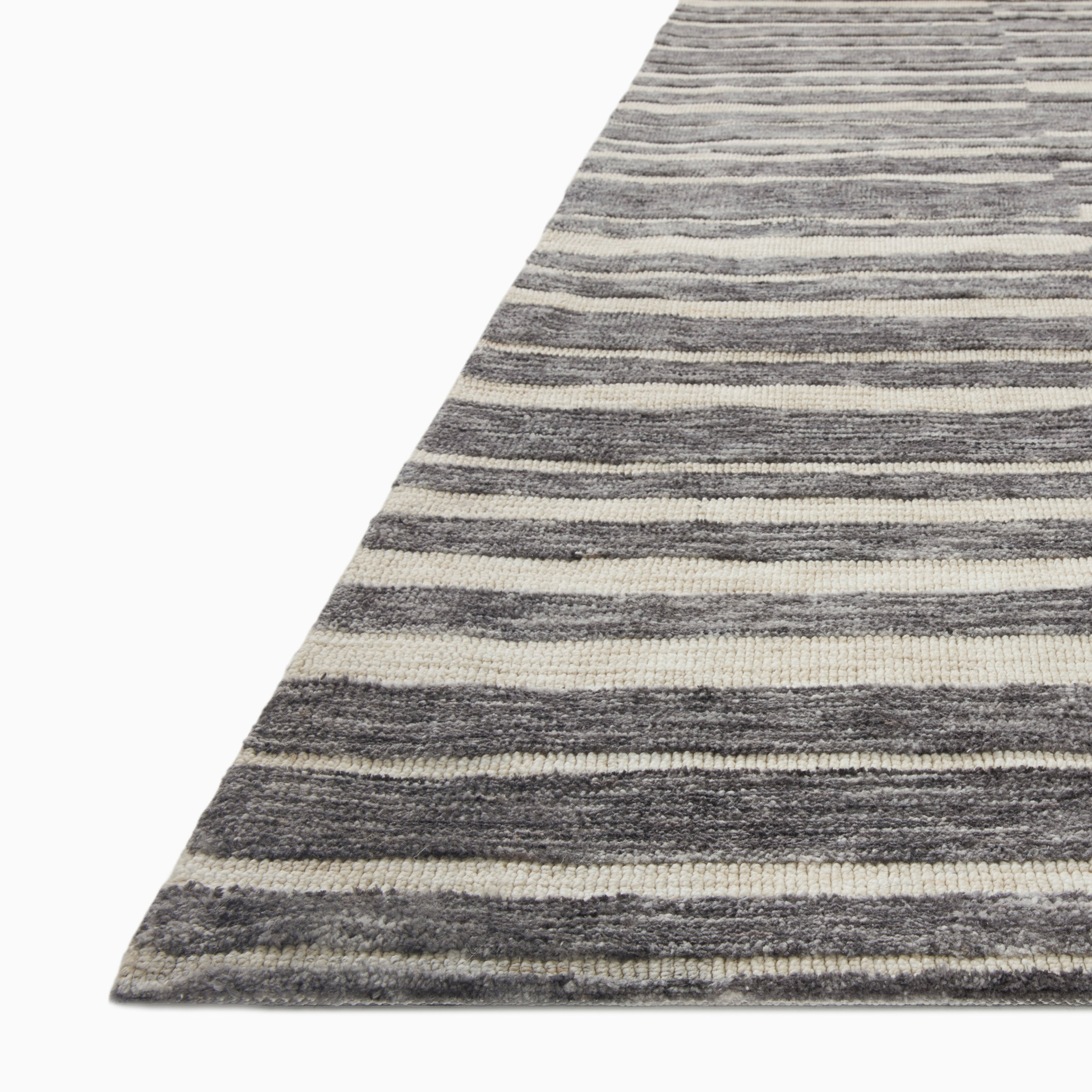 Rollins Polyester Pile Rug in Oat and Graphite, featuring a soft cream base with bold charcoal stripes for a modern, structured design.