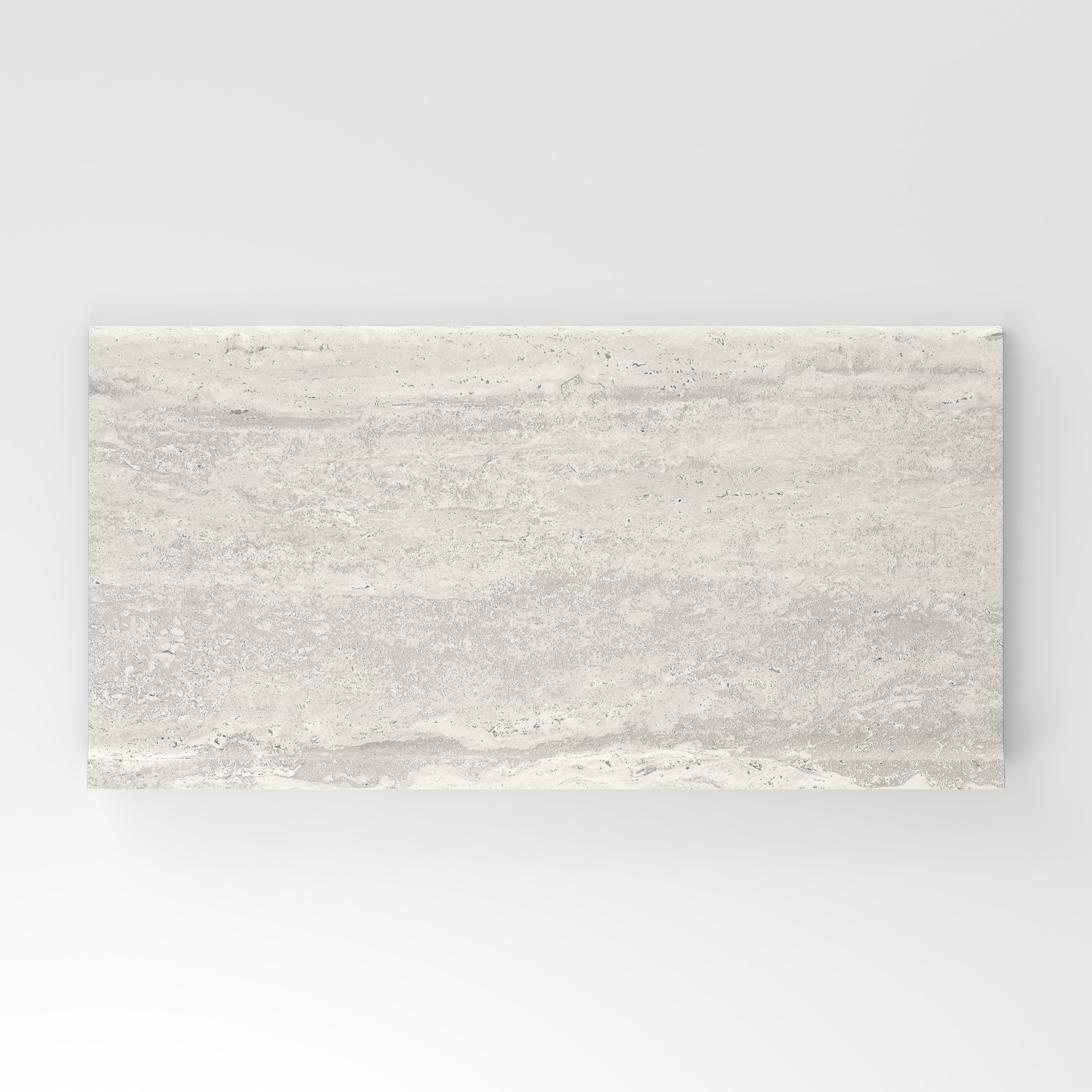 Light gray travertine-look porcelain 6x12 cove base tile with delicate linear veining, subtle texture, and a clean stone appearance.