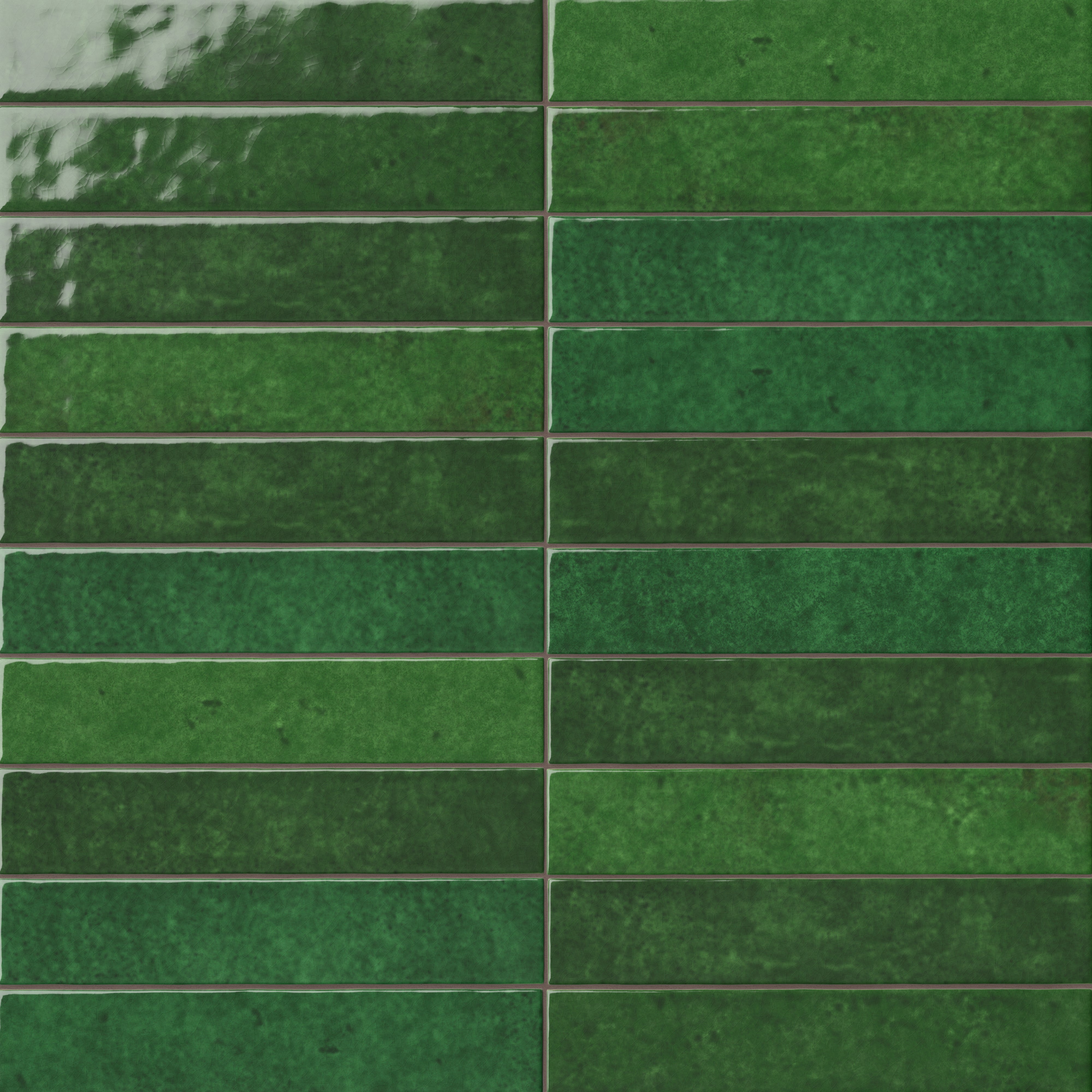 Green 2x13 ceramic wall tiles arranged in a linear layout, showcasing layered color movement, a lustrous surface, and artisanal character throughout the installation.