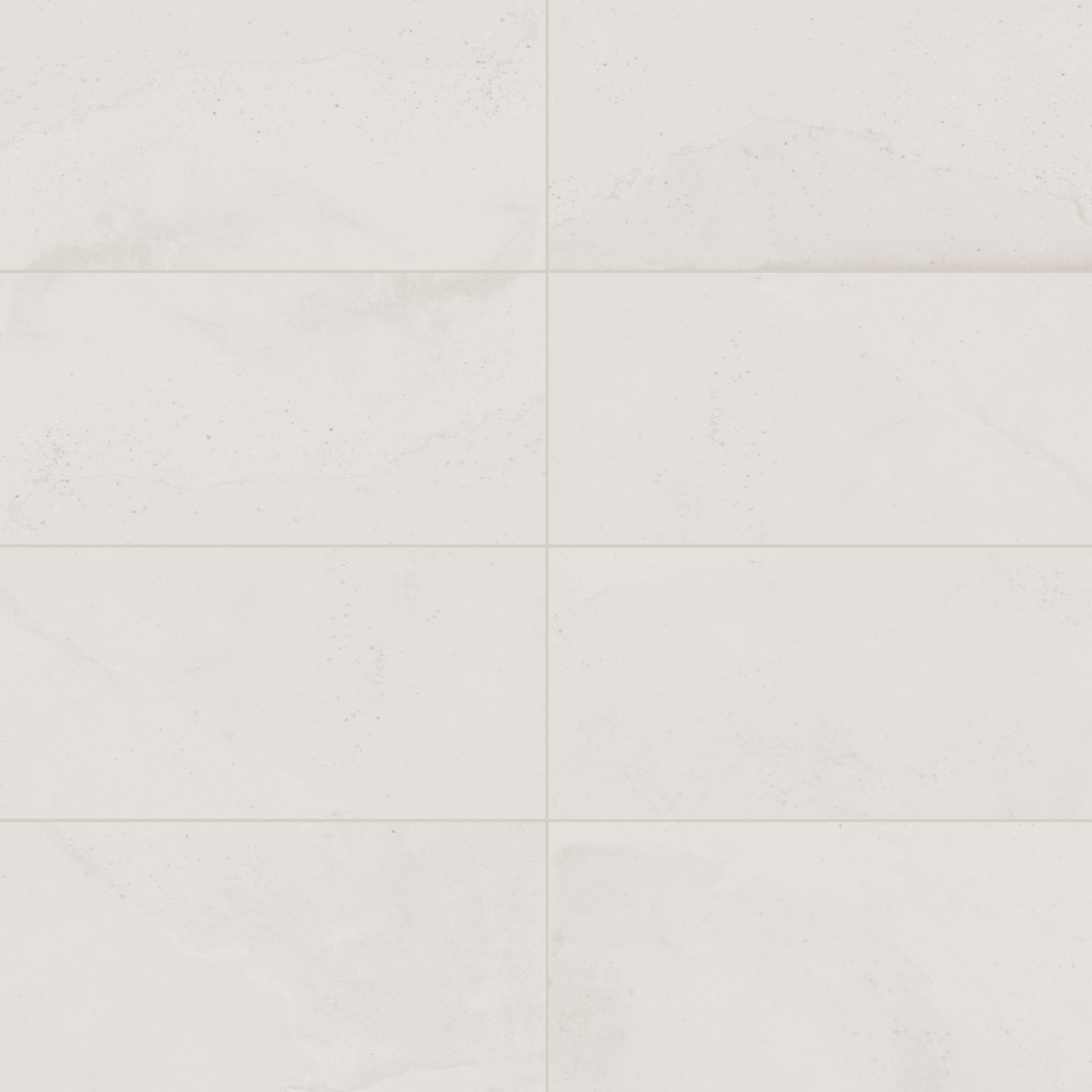 Off-white matte porcelain tile in a classic rectangular format, featuring visual mineral flecks inspired by the shifting texture of Italian Riviera sand.