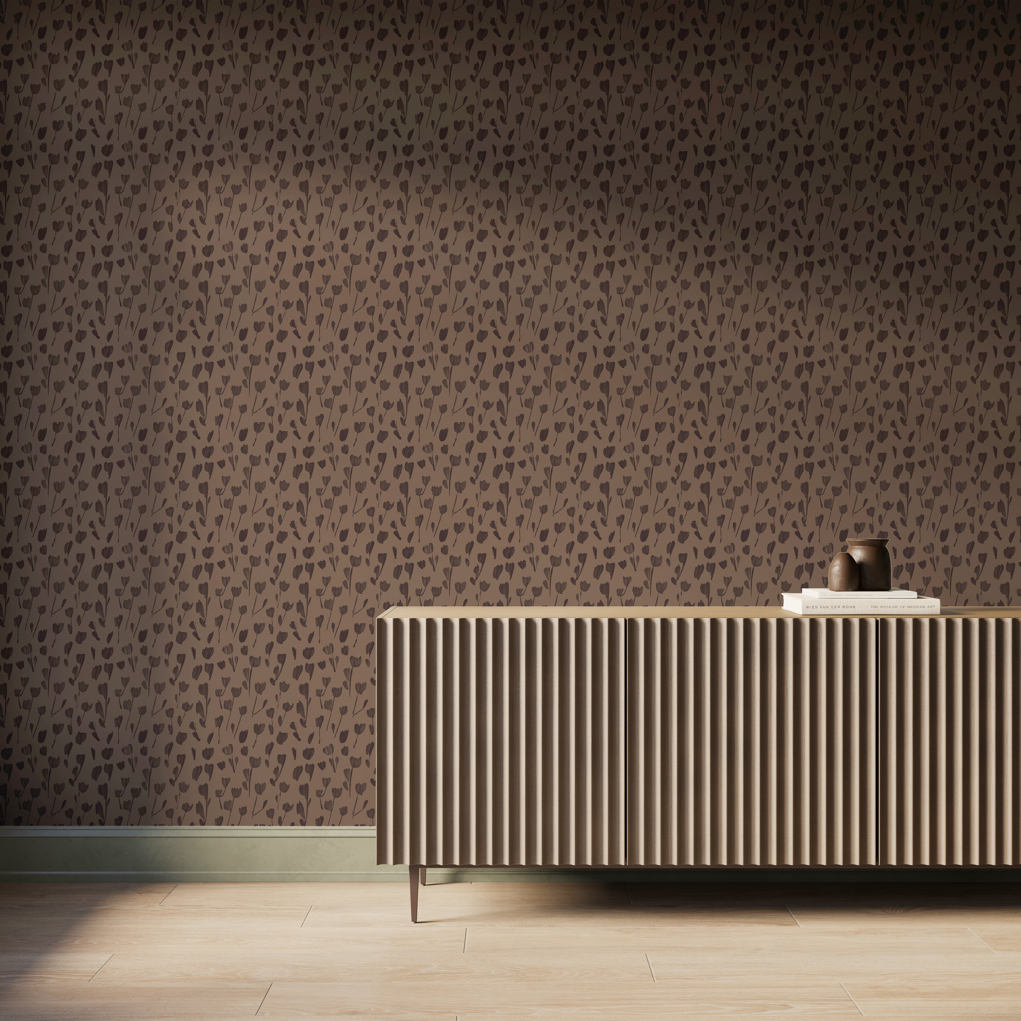 Black floral silhouettes repeat across the dark brown Petaline wallpaper in Black/Tan I, styled behind a ribbed wood console in a warm modern space.