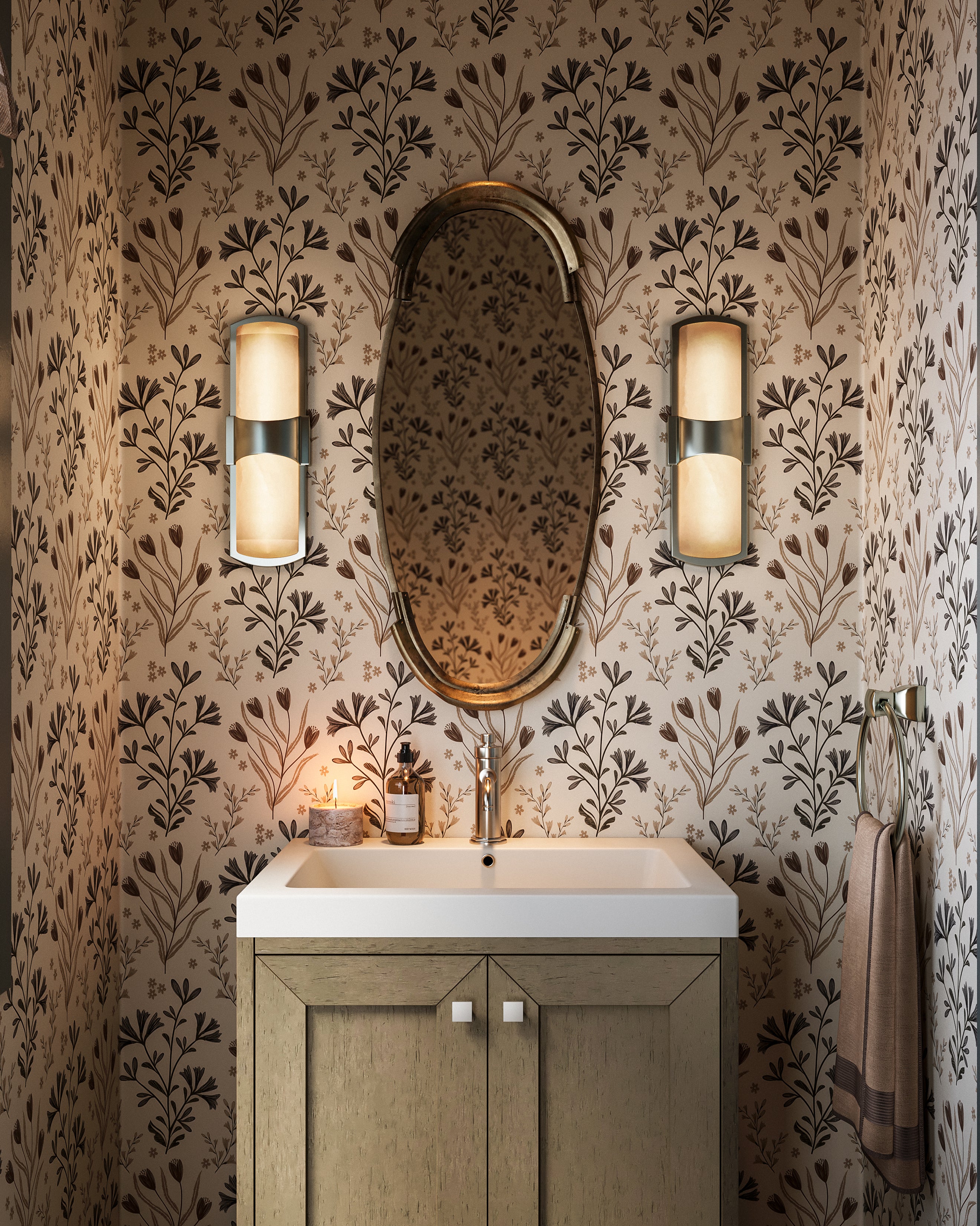 Botanical floral wallpaper with delicate hand-drawn leaves and wildflowers in soft gray, olive green, and rich brown tones set against an off-white field, styled in a bathroom behind a vanity with an oval mirror and wall sconces.