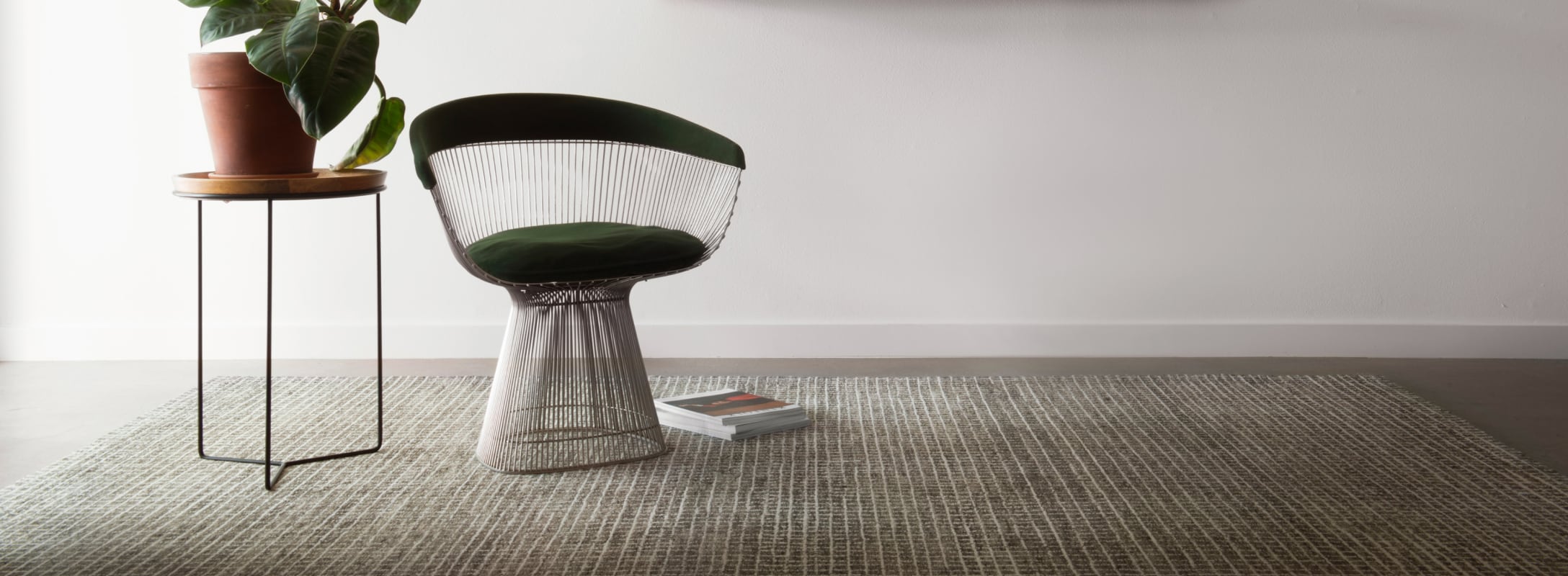 Contemporary living space featuring a soft-textured wool area rug with subtle grid patterns, paired with a chic chair and minimalist decor.