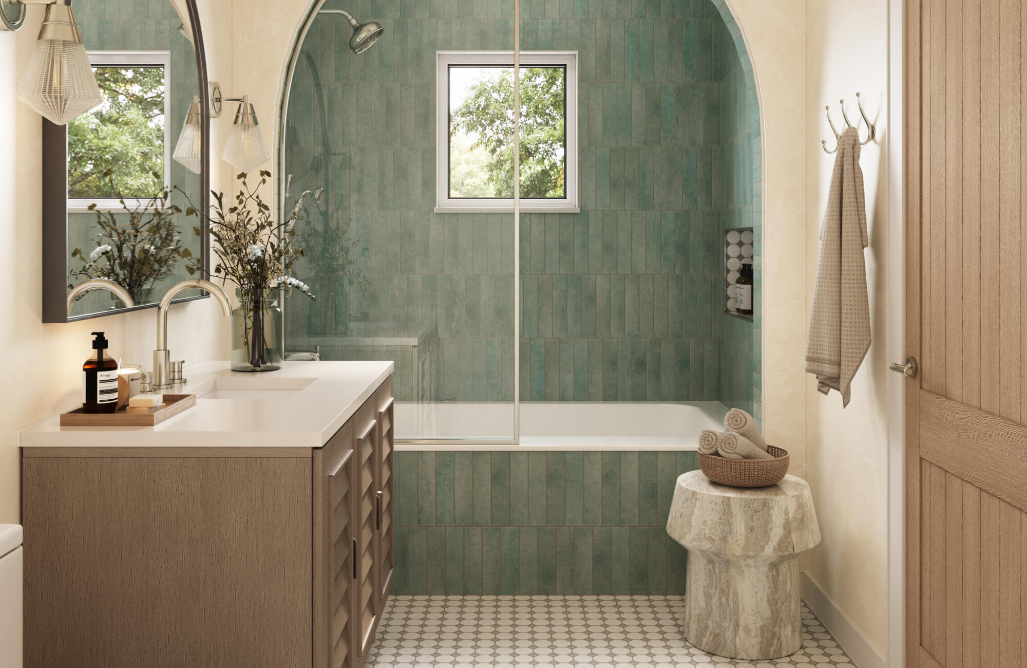 Elegant bathroom featuring vertical sage green tiles in the shower, paired with a patterned hex tile floor and wood vanity.