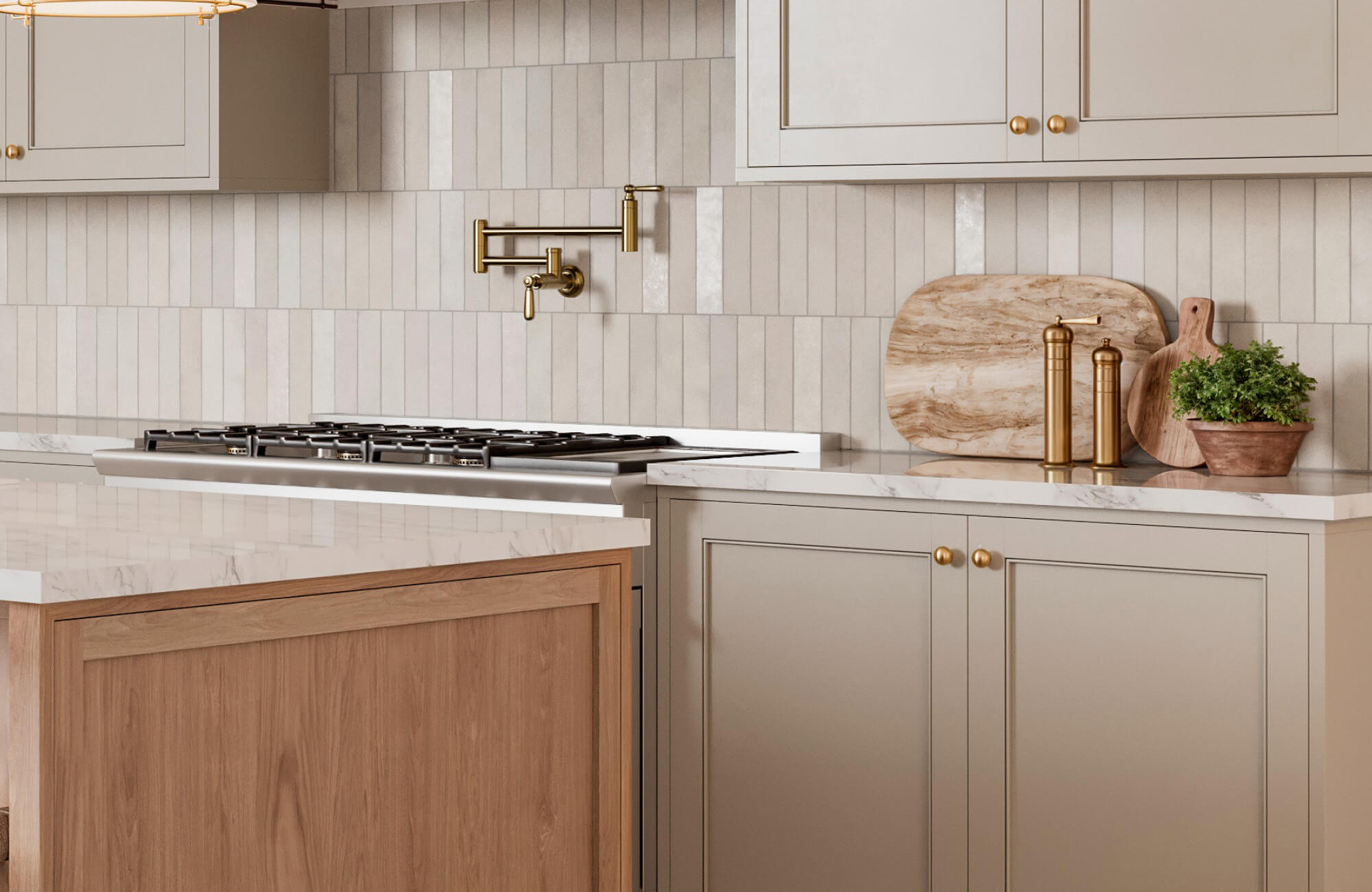 Kitchen with marble countertops, brass pot filler, wood accents, and vertical light beige backsplash tiles.