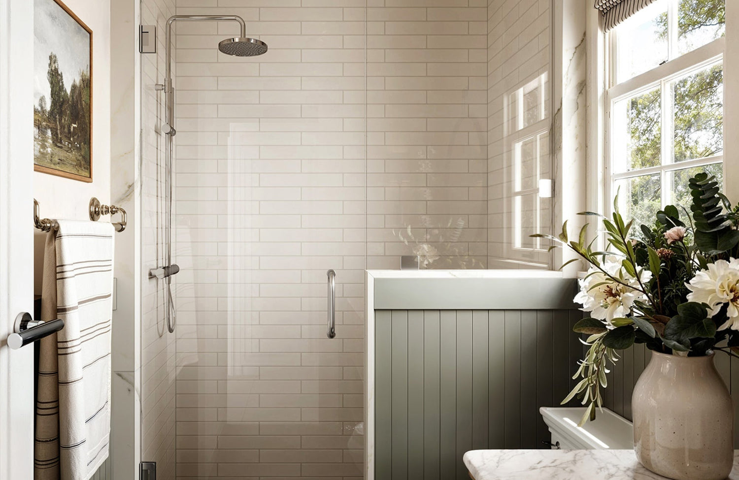 Walk-in shower with glossy white subway tiles and chrome fixtures beside a green half-wall panel.