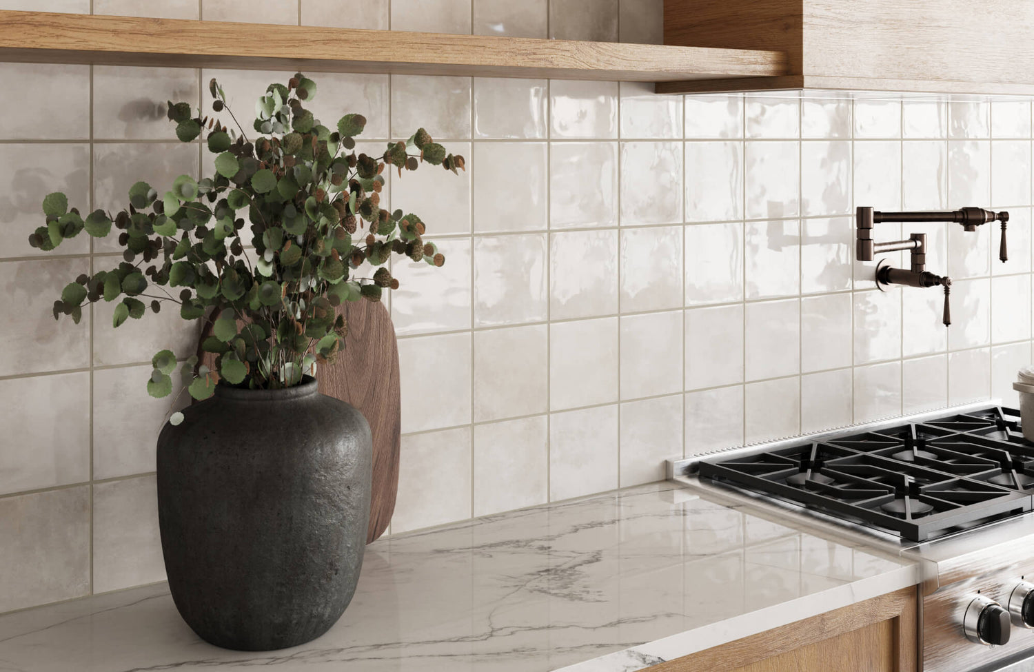 Glossy square ceramic tiles in soft cream tones enhance this elegant kitchen backsplash with artisanal charm