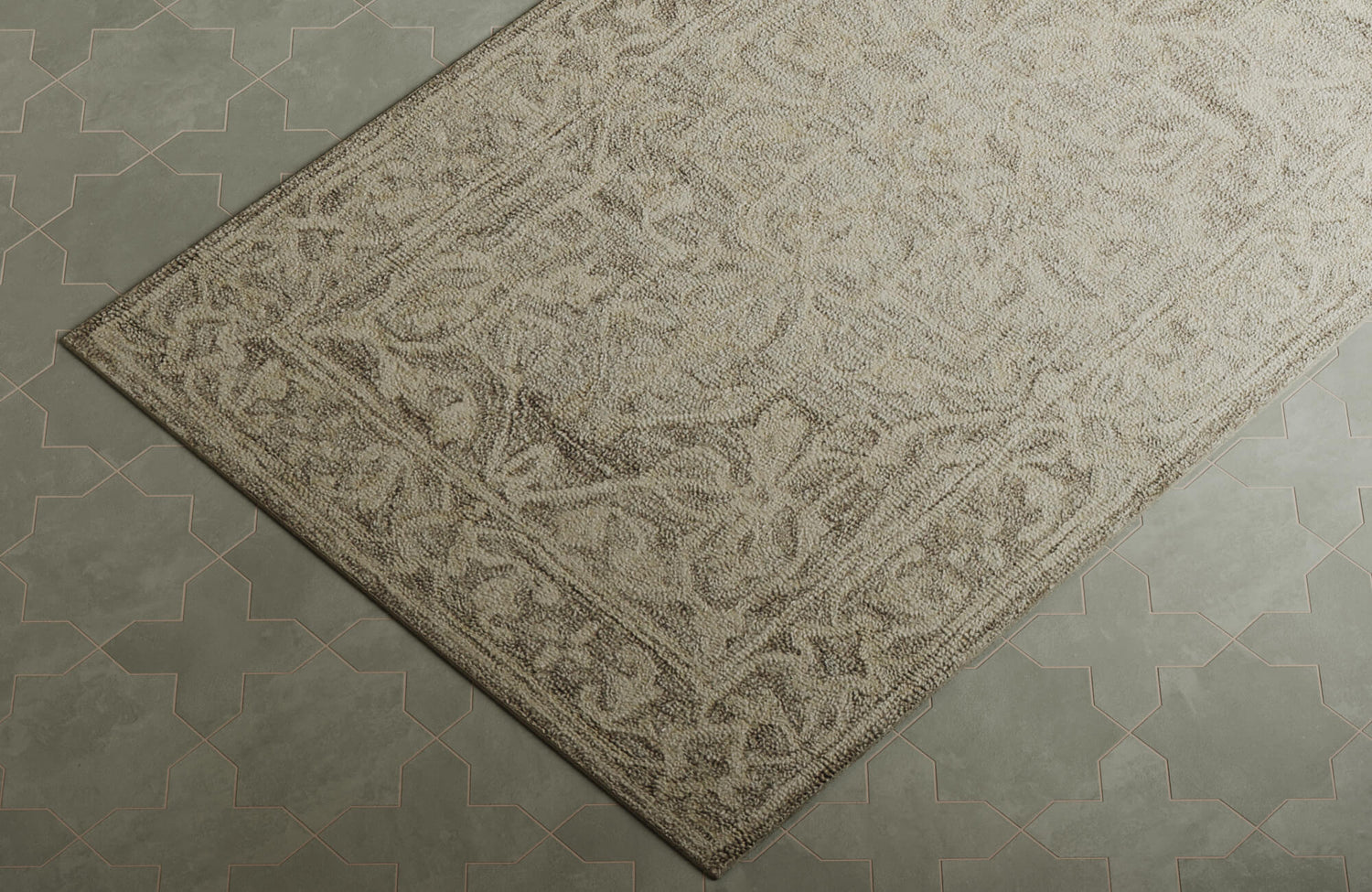 Close-up of a neutral floral rug with detailed woven motifs styled against patterned green tile flooring.
