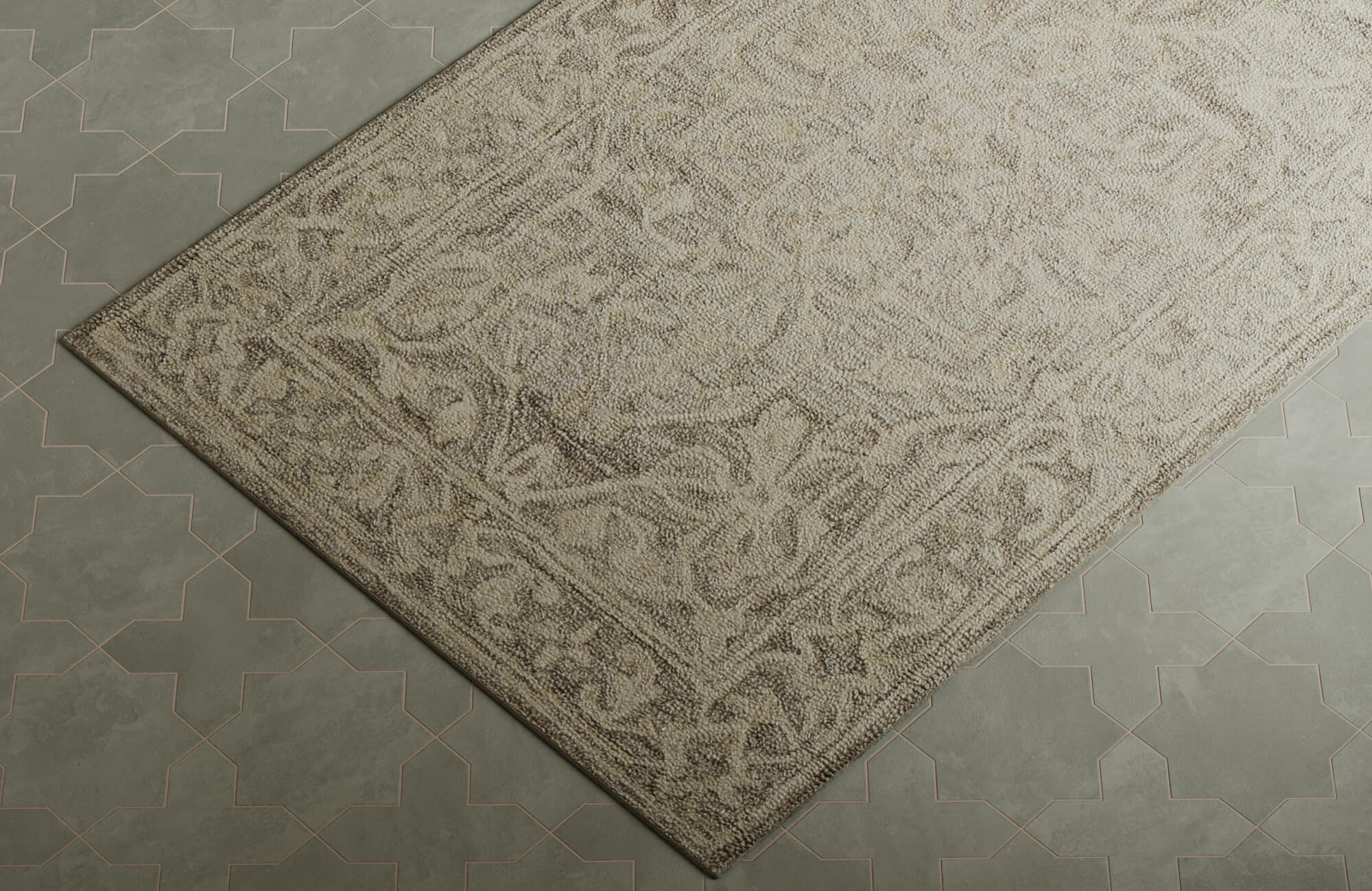 Close-up of a neutral floral rug with detailed woven motifs styled against patterned green tile flooring.