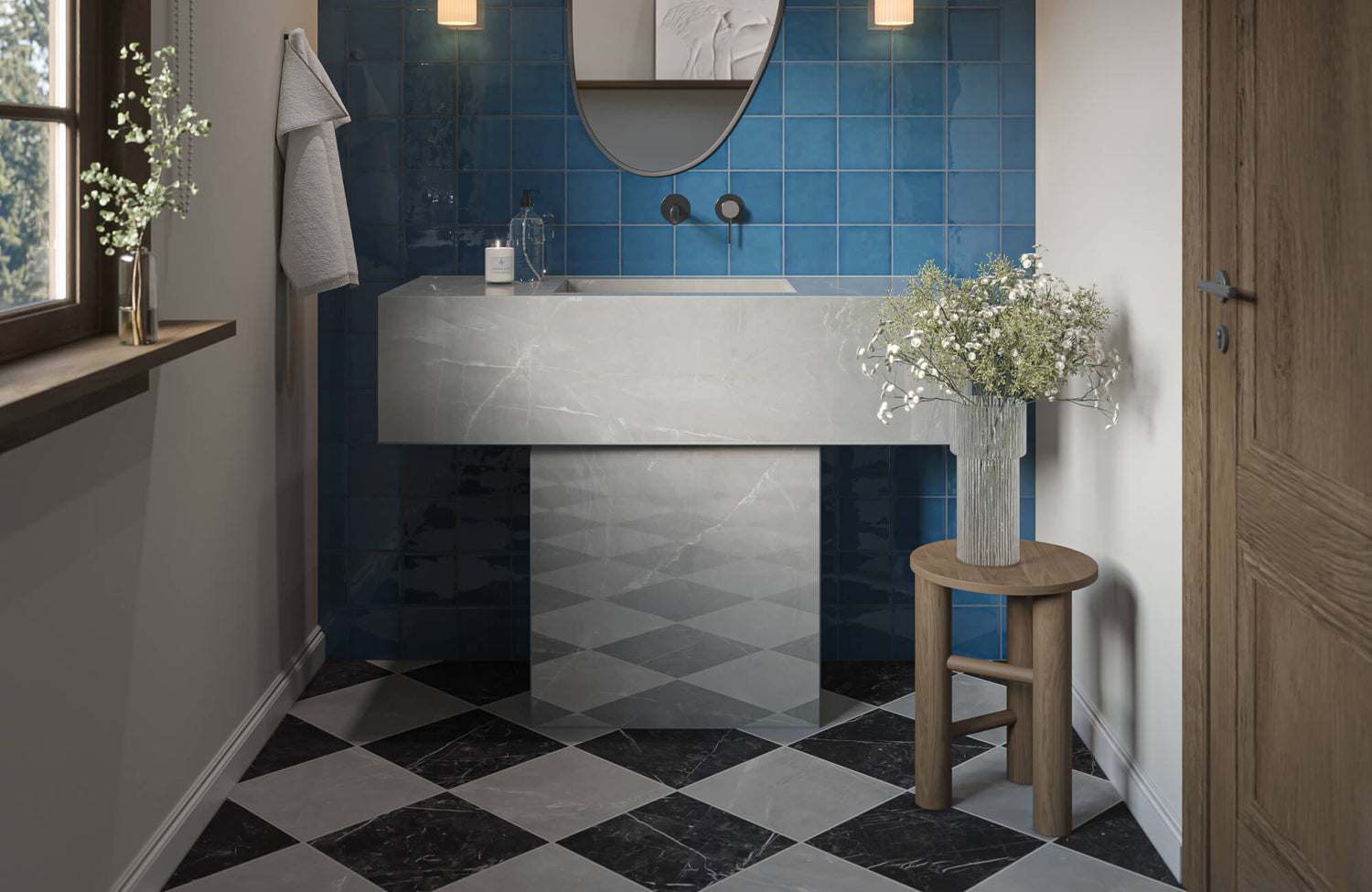 Contemporary bathroom with deep blue wall tiles, a sculptural marble sink, and checkered black-and-gray tile flooring.