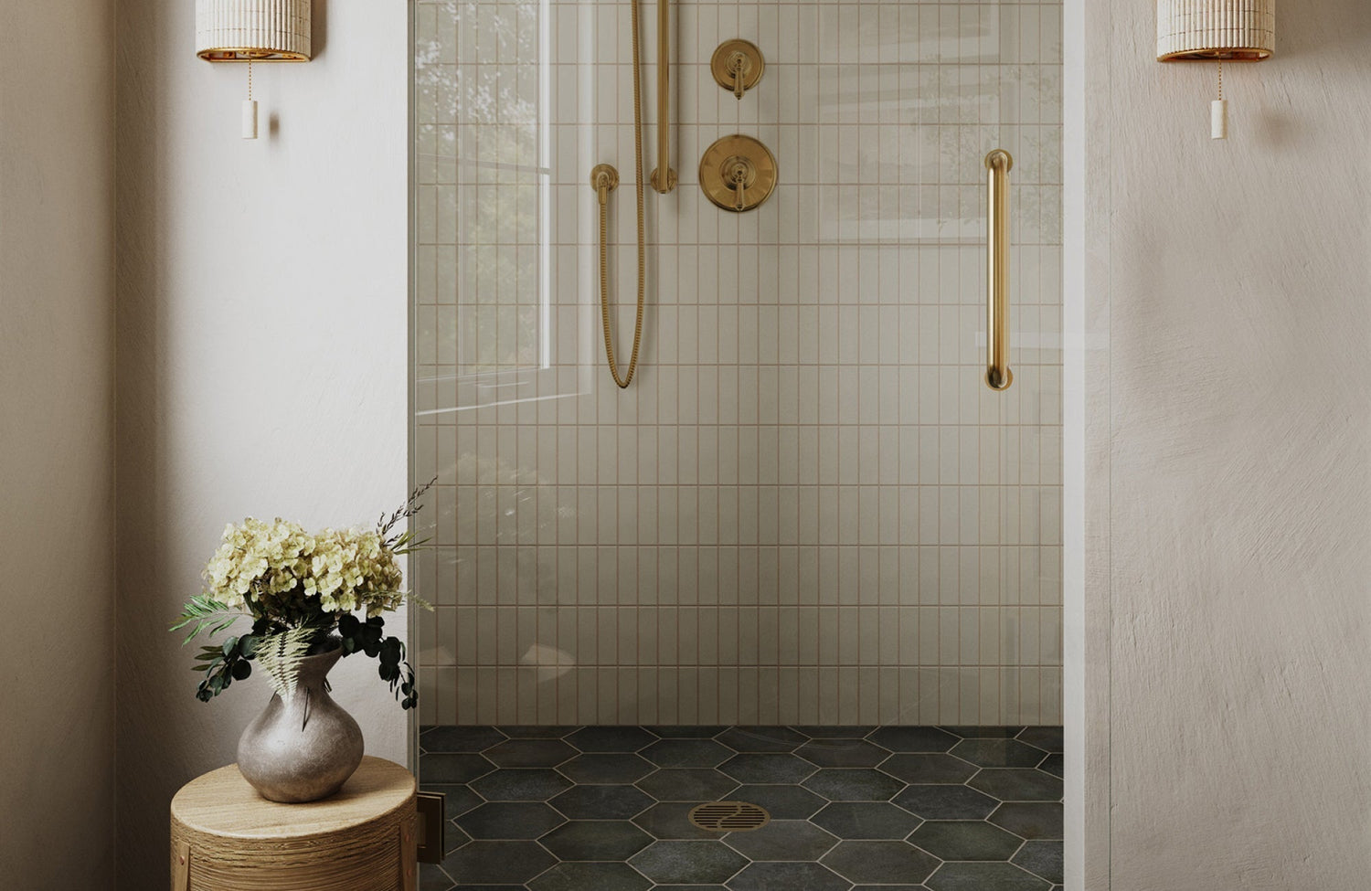 Neutral shower with vertical wall tiles and dark hexagon floor tiles creating contrast and visual depth.