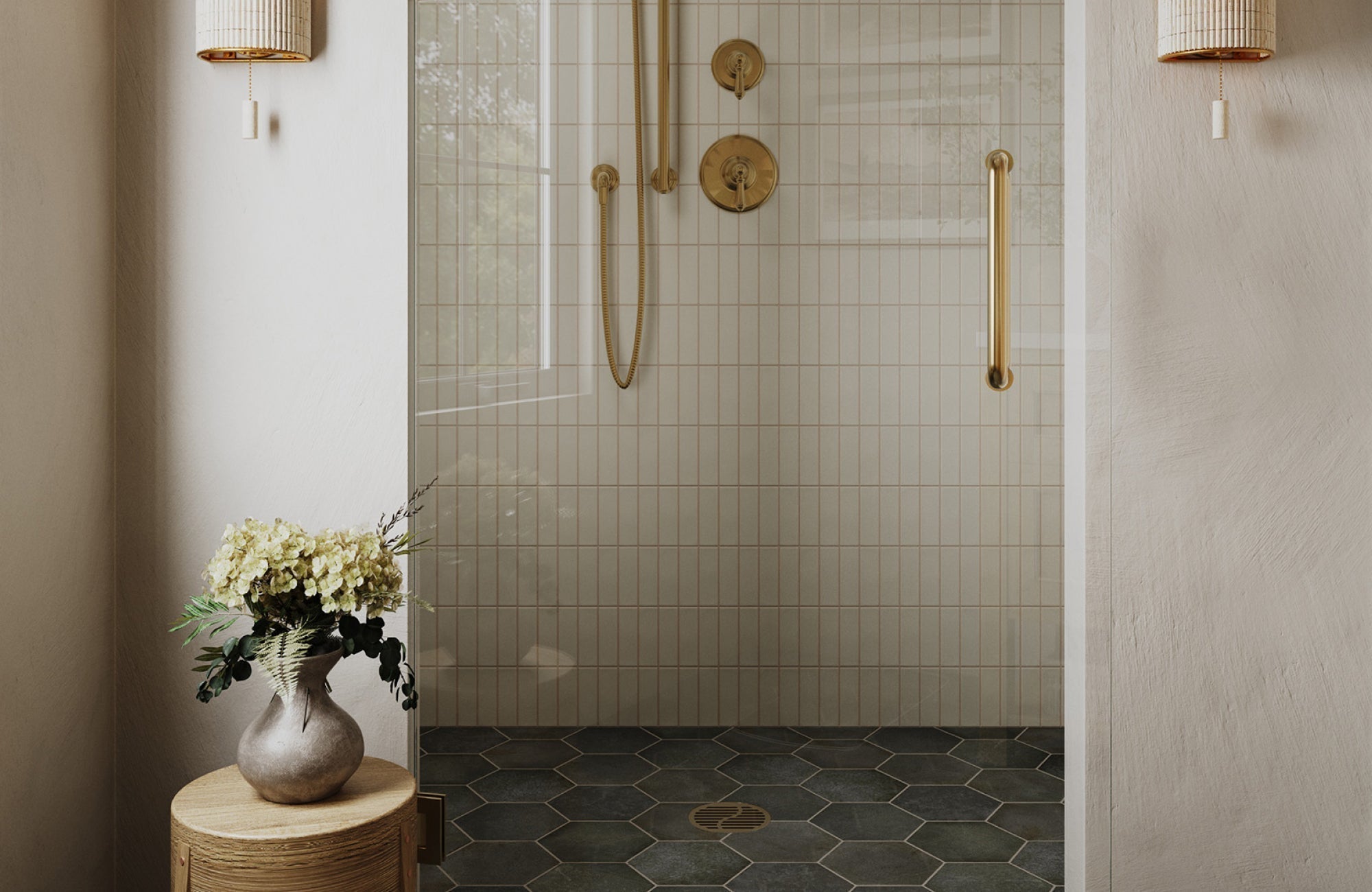 Neutral shower with vertical wall tiles and dark hexagon floor tiles creating contrast and visual depth.