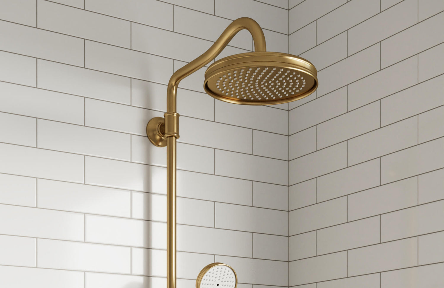 Glossy white subway tiles with clean grout lines create a timeless backdrop for a luxe brushed gold rain shower.