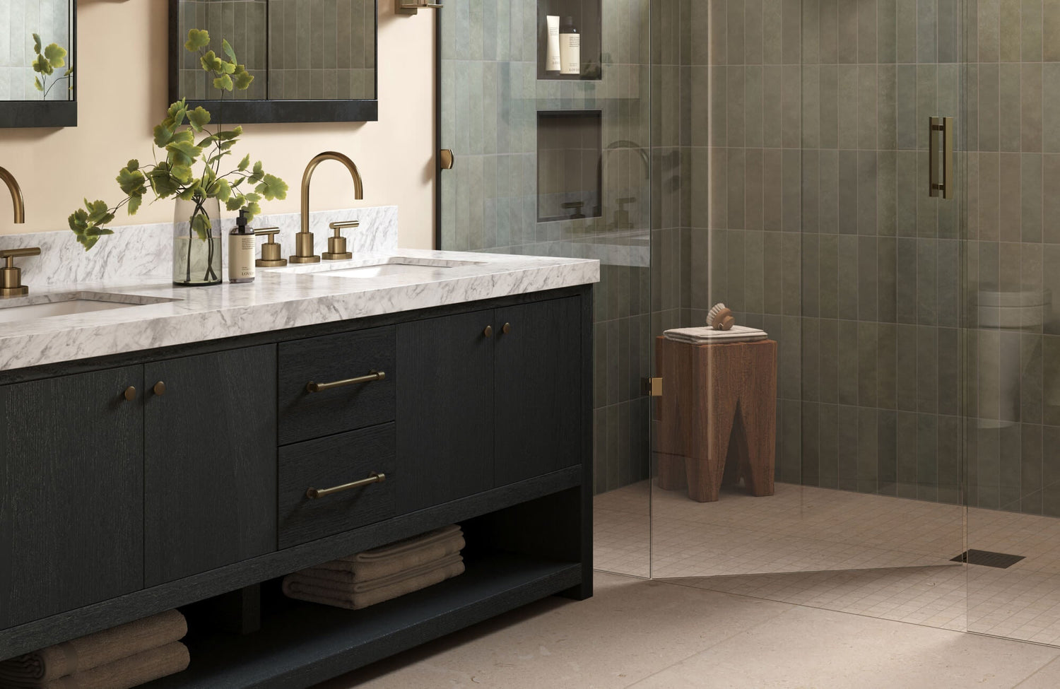 Elegant bathroom with green vertical subway tiles, black marble vanity, and brushed brass fixtures.