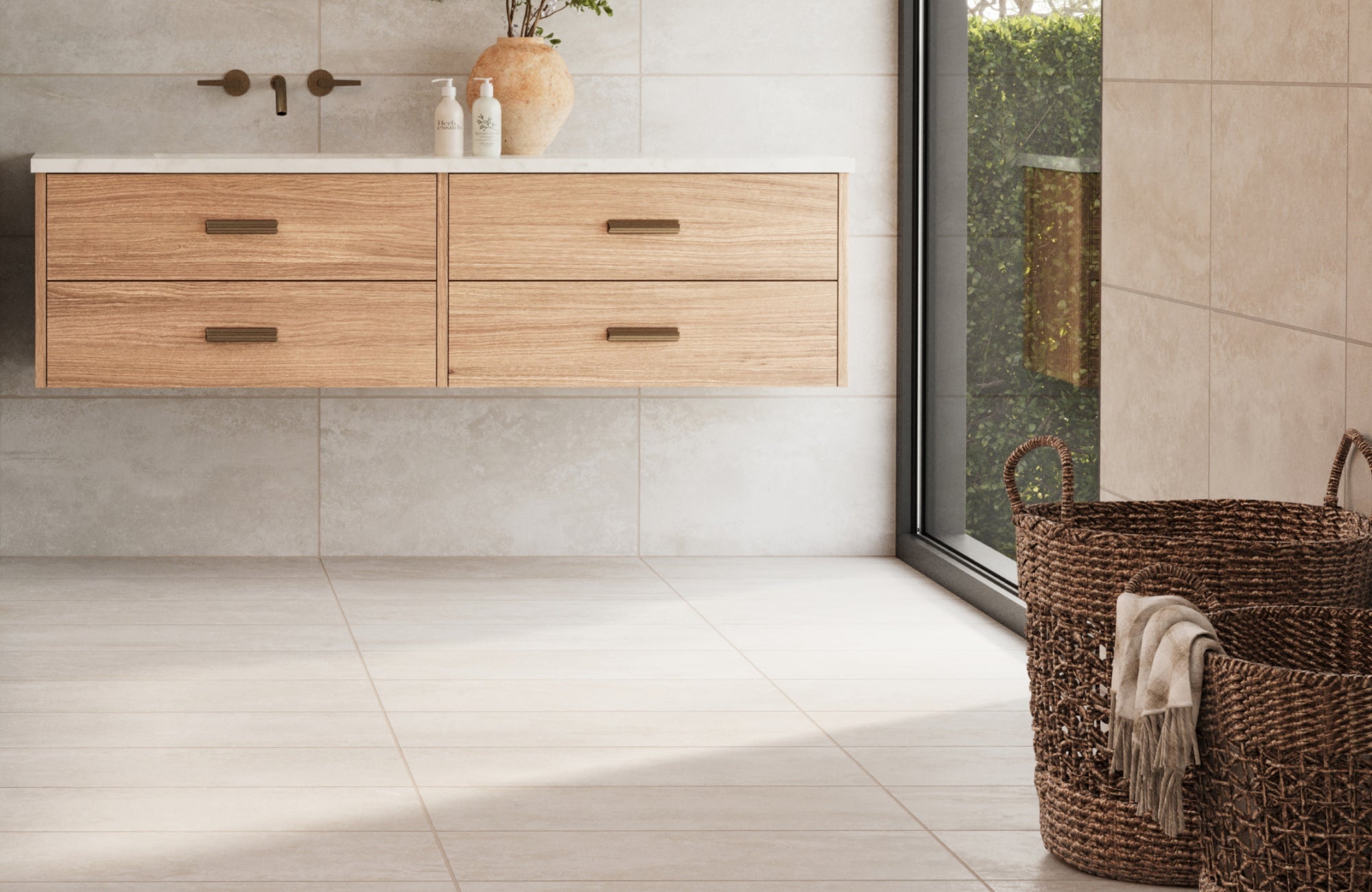 Minimalist bathroom with matte ceramic tiles on the floor and walls, a floating wood vanity, and woven baskets for added texture.
