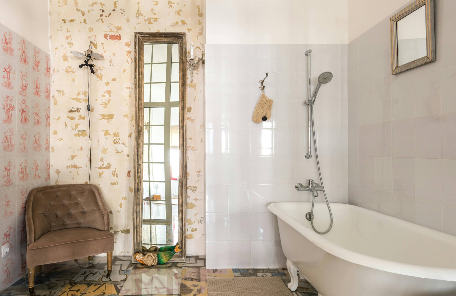 Eclectic bathroom with glossy white wall tiles, vintage clawfoot tub, and a rustic full length mirror leaning against distressed plaster.