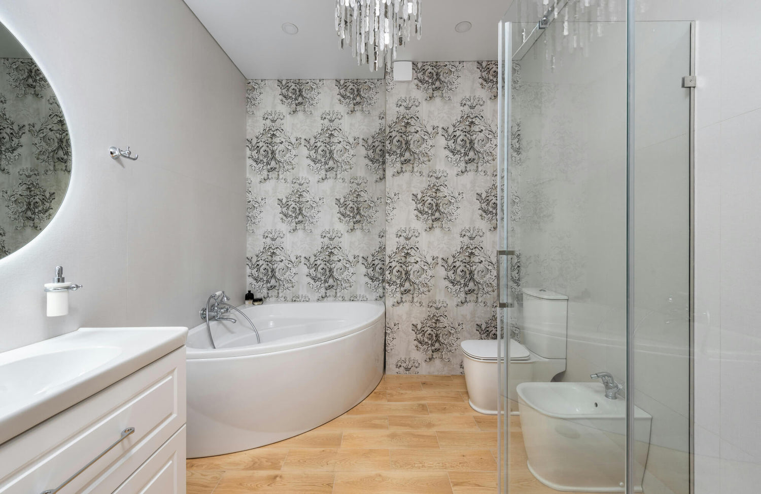 A stylish bathroom with peel-and-stick patterned wallpaper and wood flooring showing safe areas for peel-and-stick applications.
