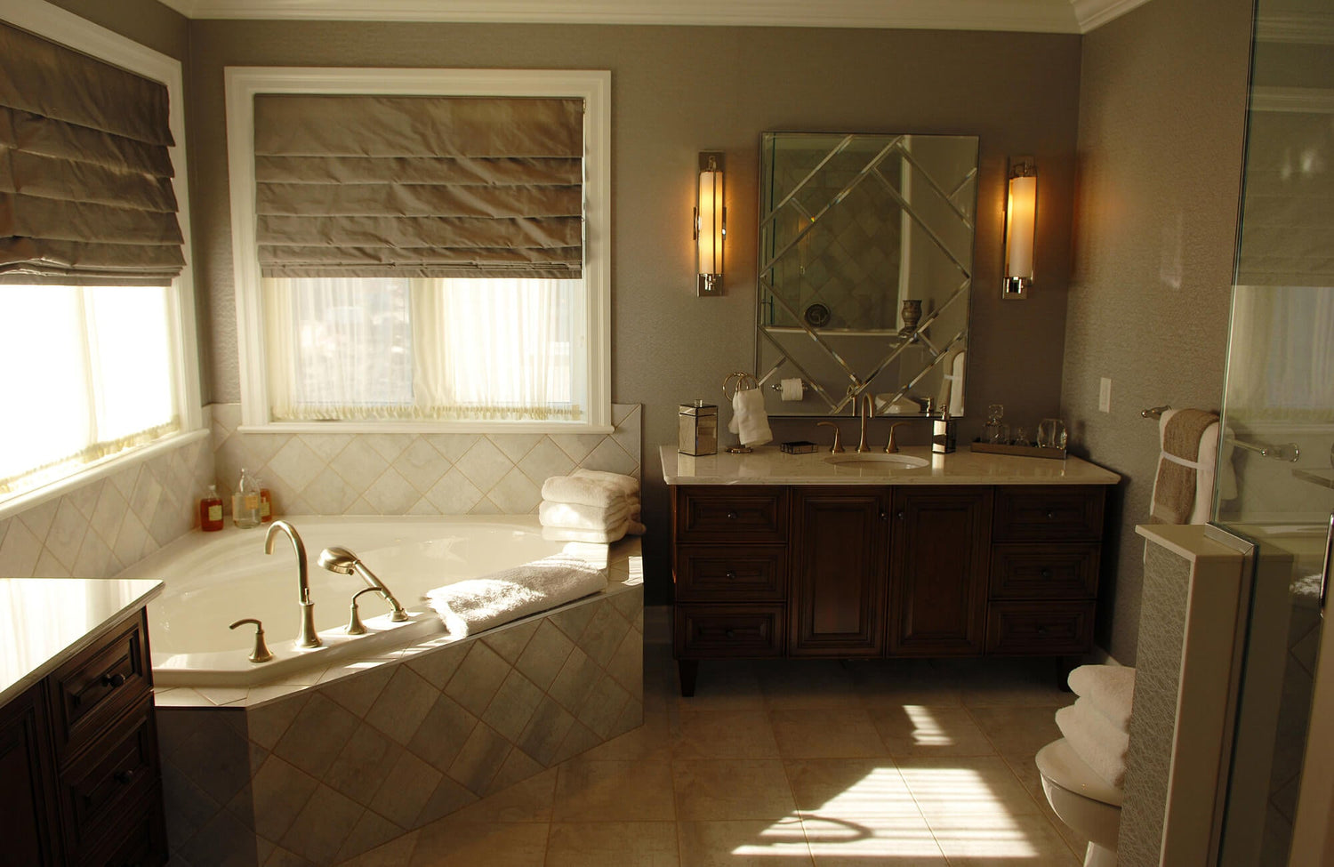 Traditional bathroom vanity with multiple drawers and cabinets, offering generous storage alongside a soaking tub and classic finishes.