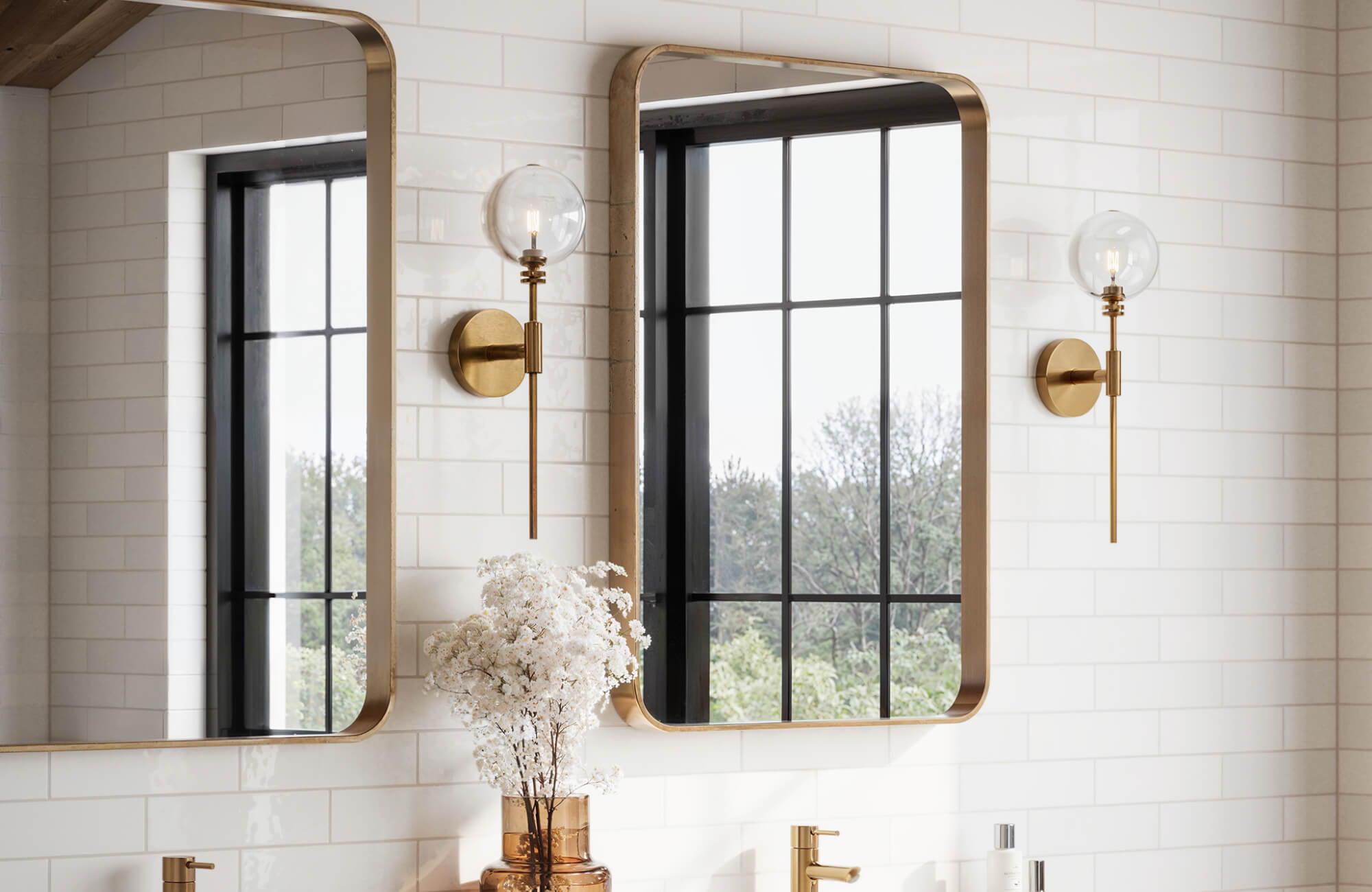 Sleek white subway tiles with a glossy finish create a bright, timeless backdrop in this modern double vanity bathroom.
