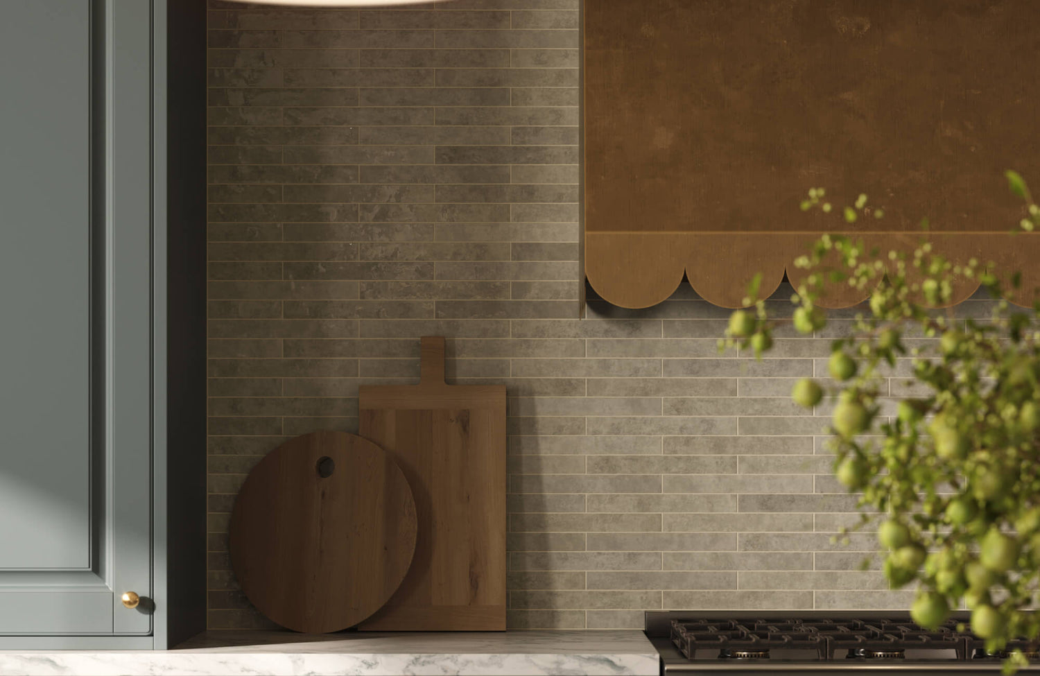 Horizontal brick-style backsplash tile in earthy beige tones, adding quiet texture behind a cooktop and layered wood accents.