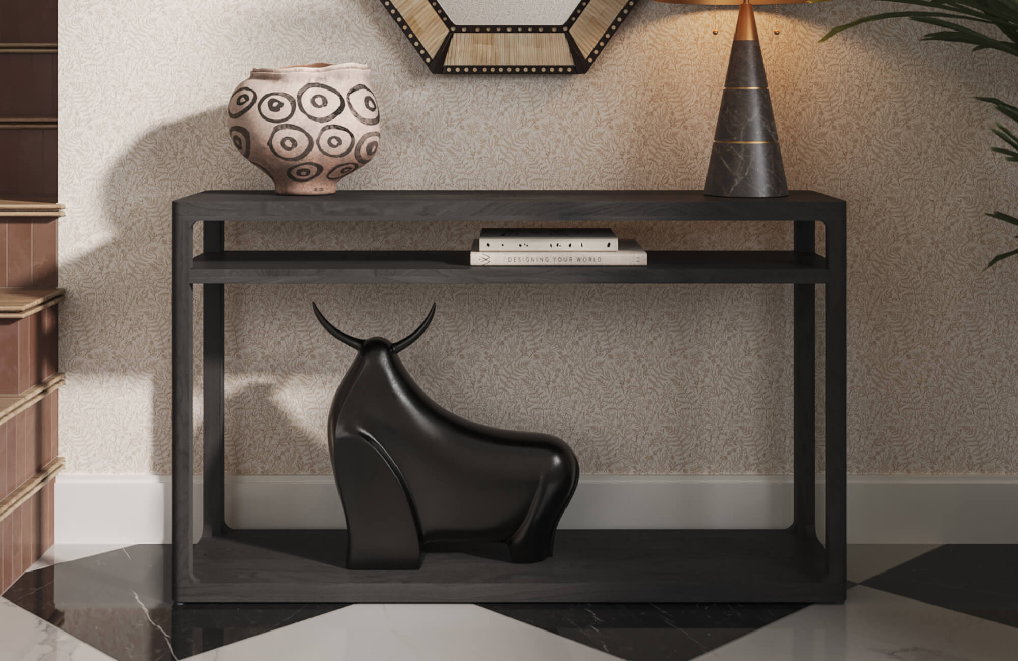 Eclectic entryway with botanical wallpaper, black console table, black bull sculpture, patterned decorative vase, geometric wall mirror, cone-shaped table lamp, and black and white marble look tile flooring.