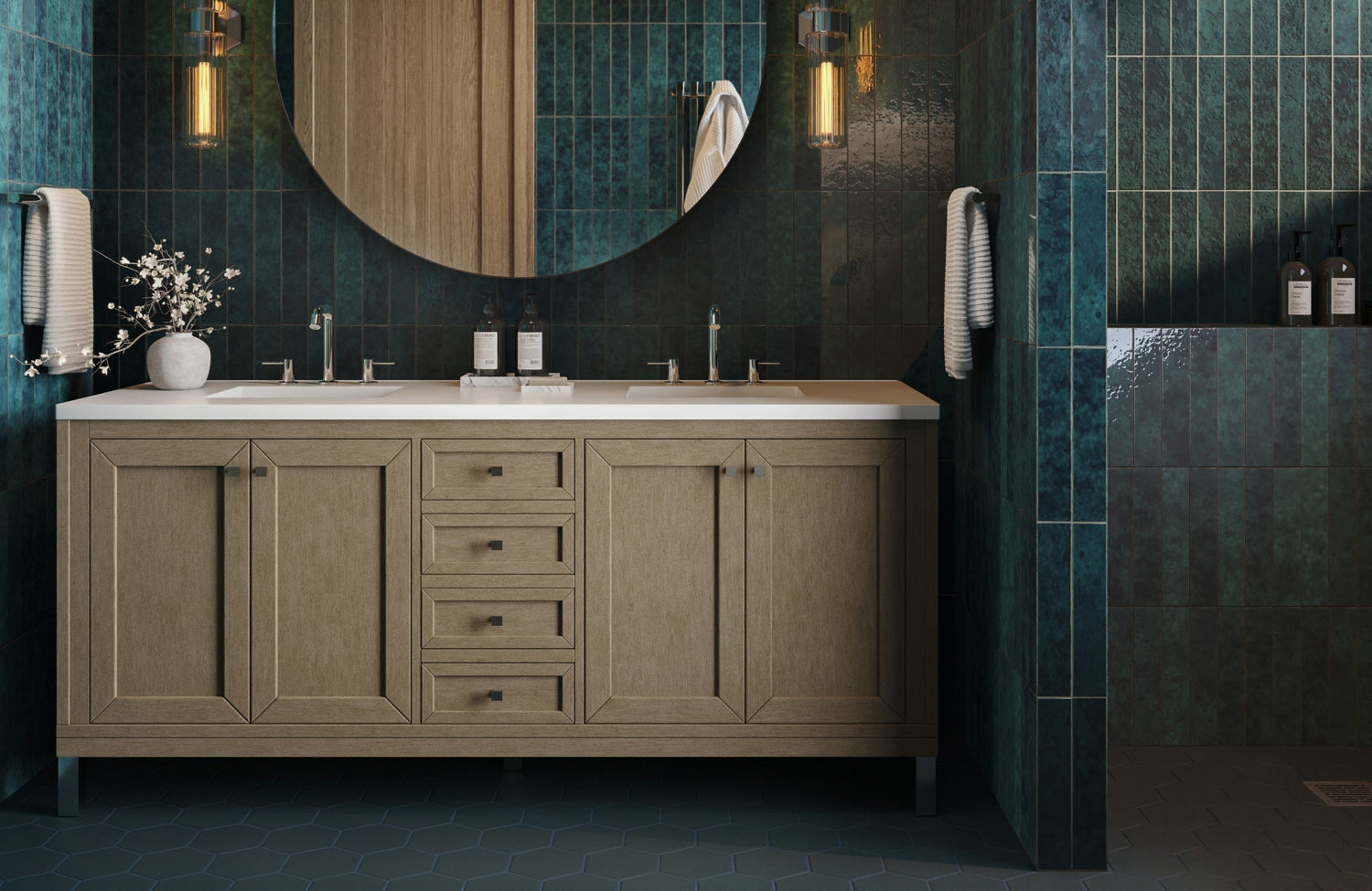 Bathroom with blue vertical subway tile walls, hexagon floor tile, double vanity, round mirror, and modern wall sconces.