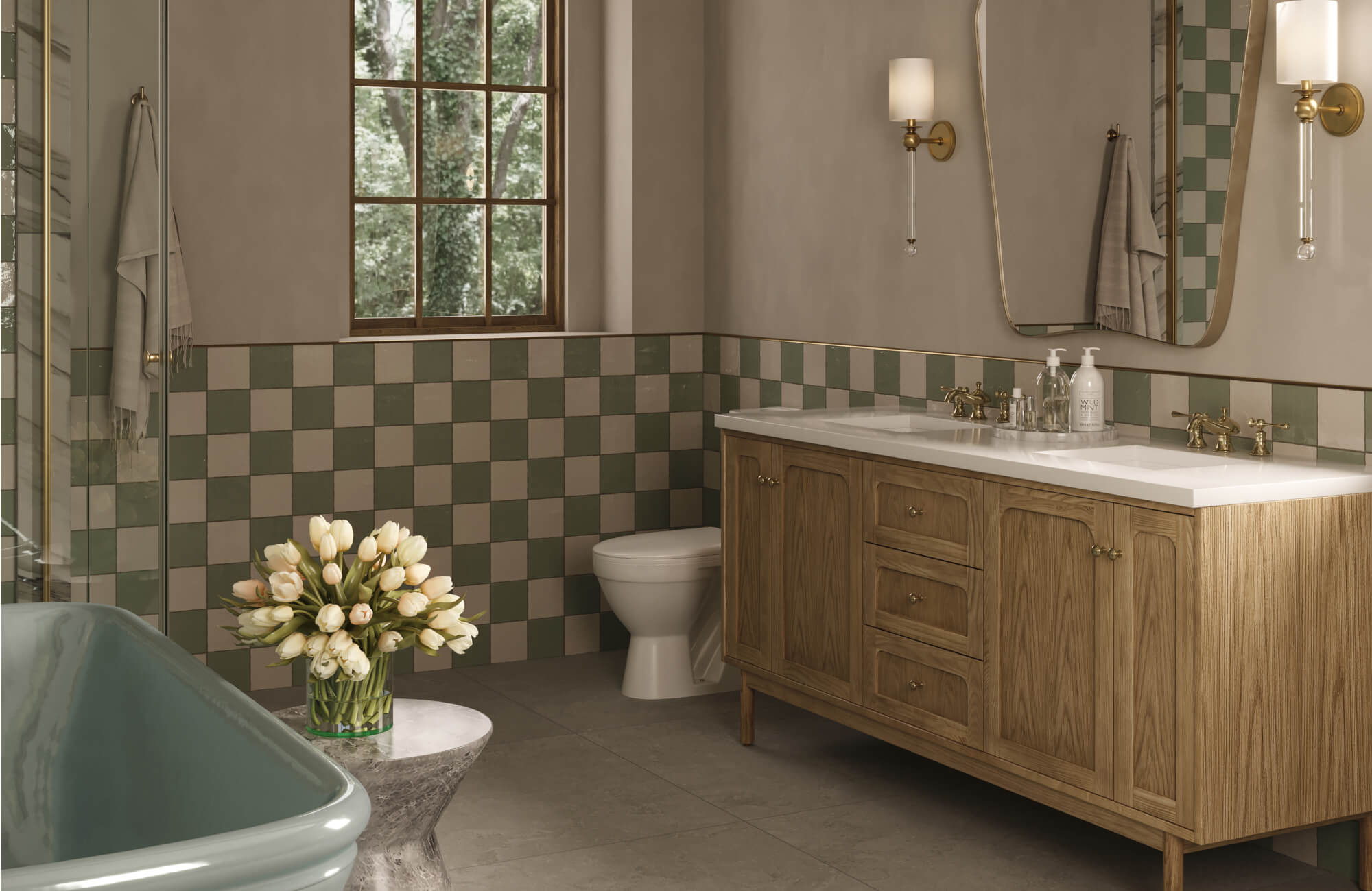 Charming bathroom with sage and cream checkered tiles, oak vanity, sculptural mirror, and elegant wall sconces.