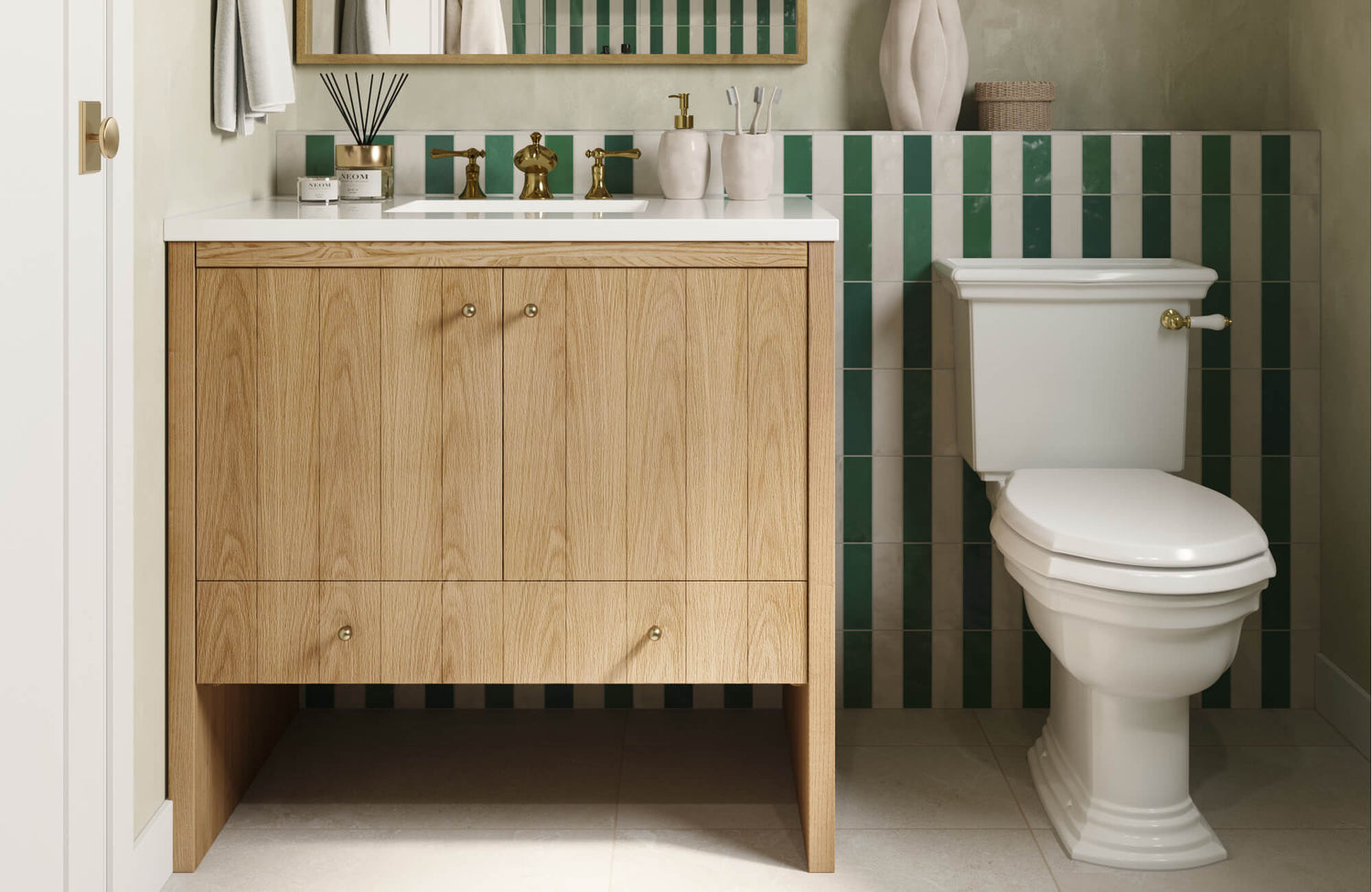 Vertical green and cream wall tiles accent a powder room vanity with warm wood cabinetry and brass fixtures.