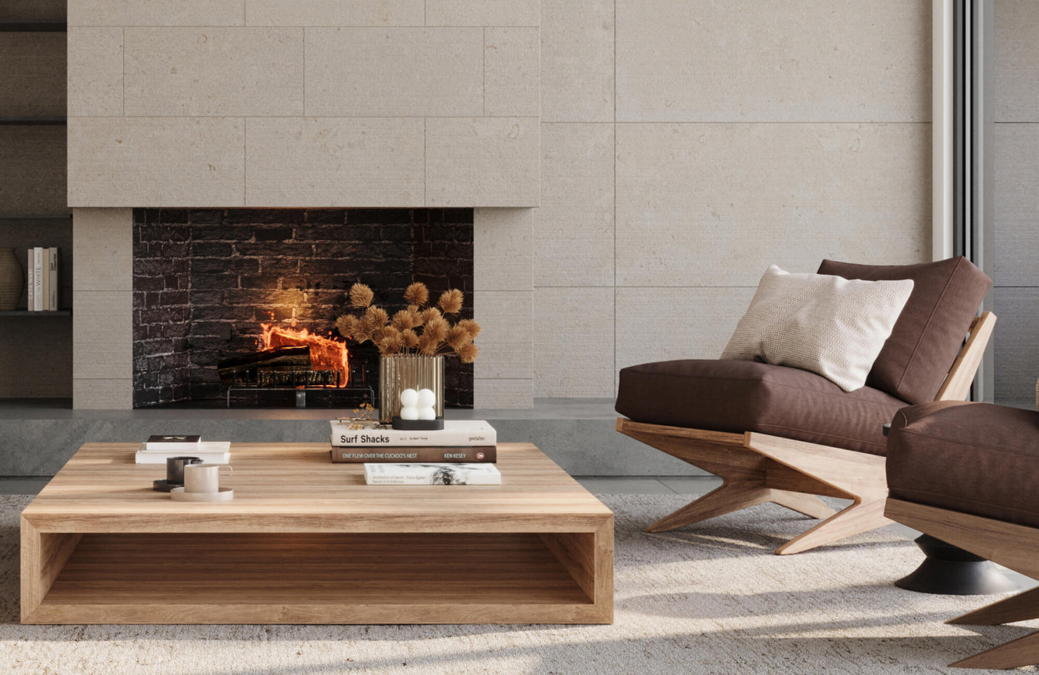 Modern living room with a large neutral area rug layered beneath a low-profile oak coffee table and sculptural brown leather lounge chairs, set against a floor-to-ceiling limestone fireplace with a black brick firebox and warm ambient lighting.