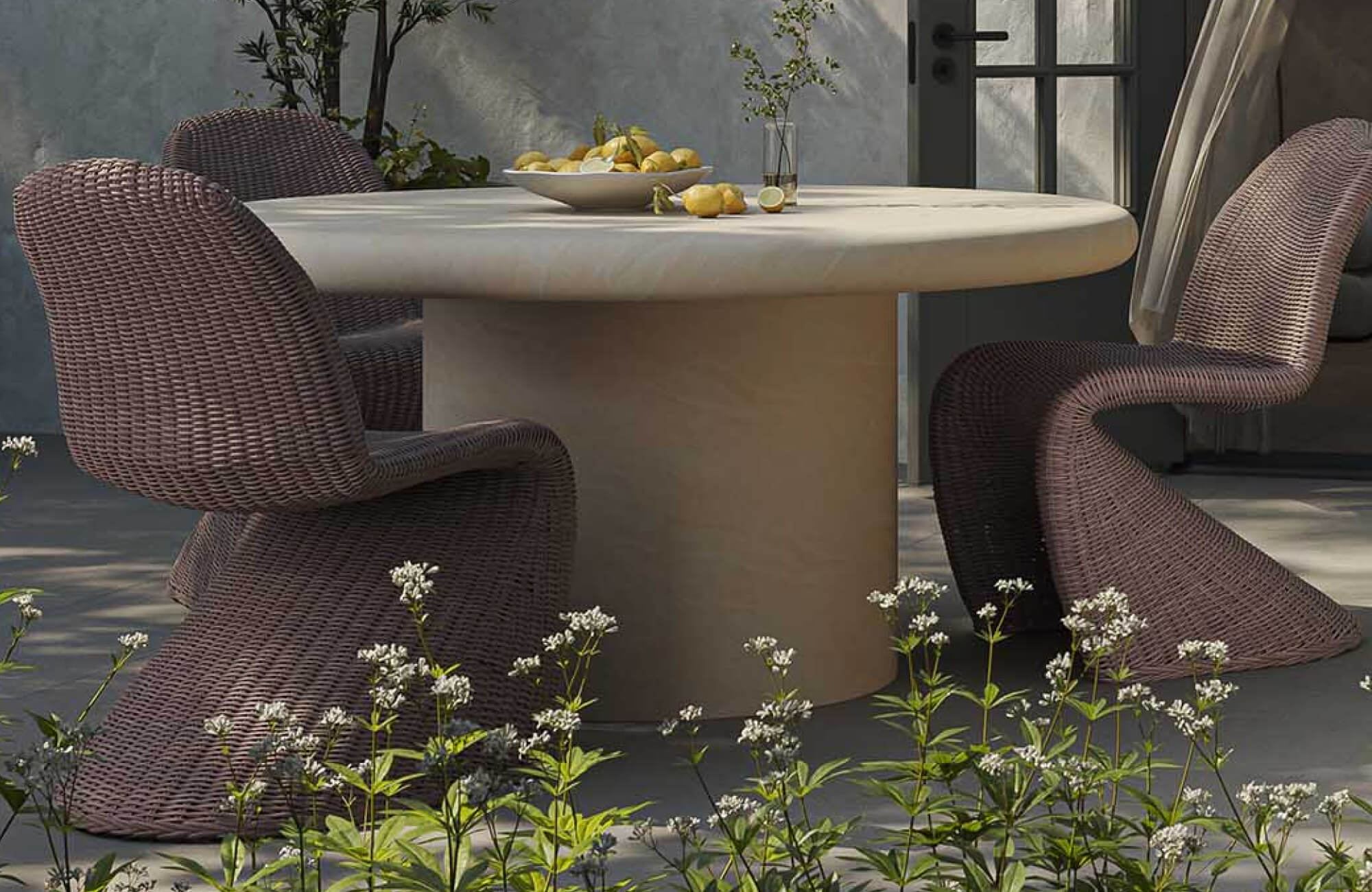 Outdoor dining chair with sculptural curved silhouette and woven texture, paired with a round table in a modern patio dining set surrounded by greenery.