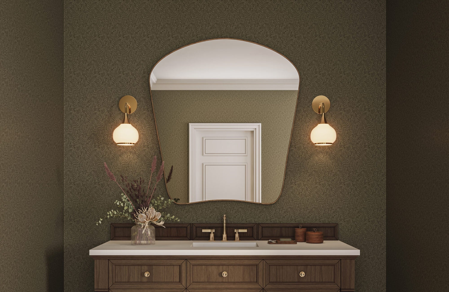 Statement bathroom design featuring textured green wallpaper, asymmetrical wall mirror, warm wood cabinetry, and soft globe wall lights.