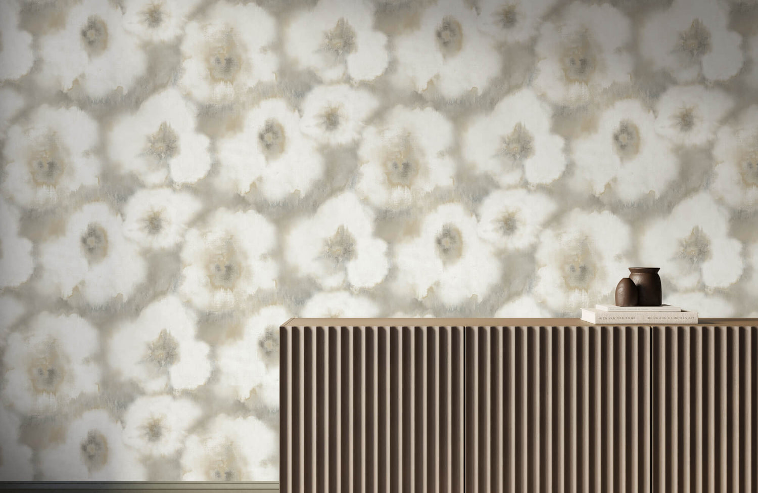 Soft neutral floral wallpaper with large watercolor-style white blooms behind a ribbed wood console topped with books and a small brown vase.