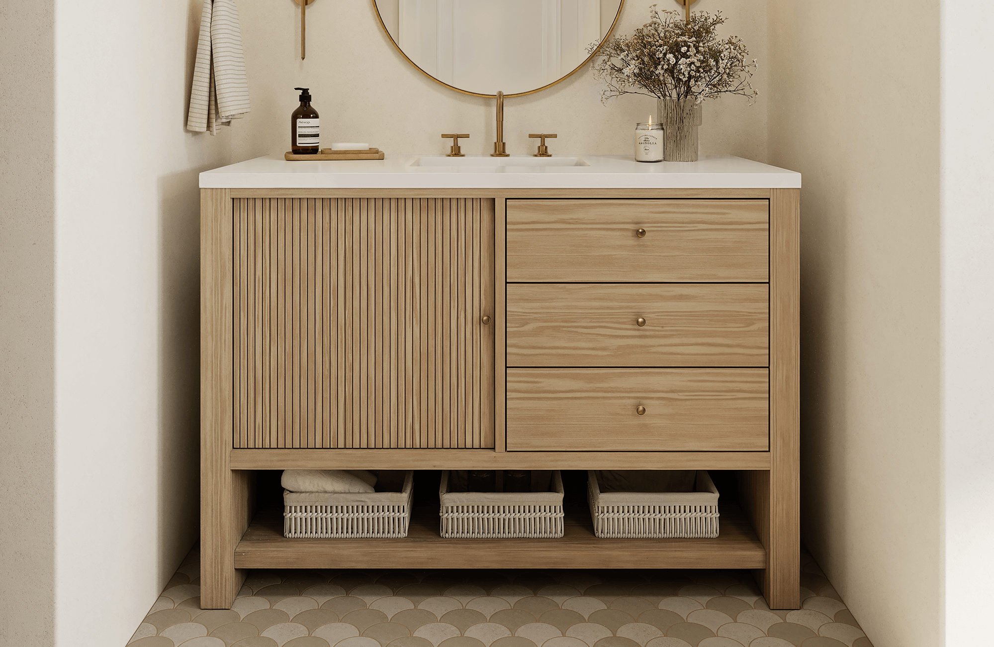 Bathroom vanity with light wood cabinet, round mirror, and traditional scalloped floor tiles.