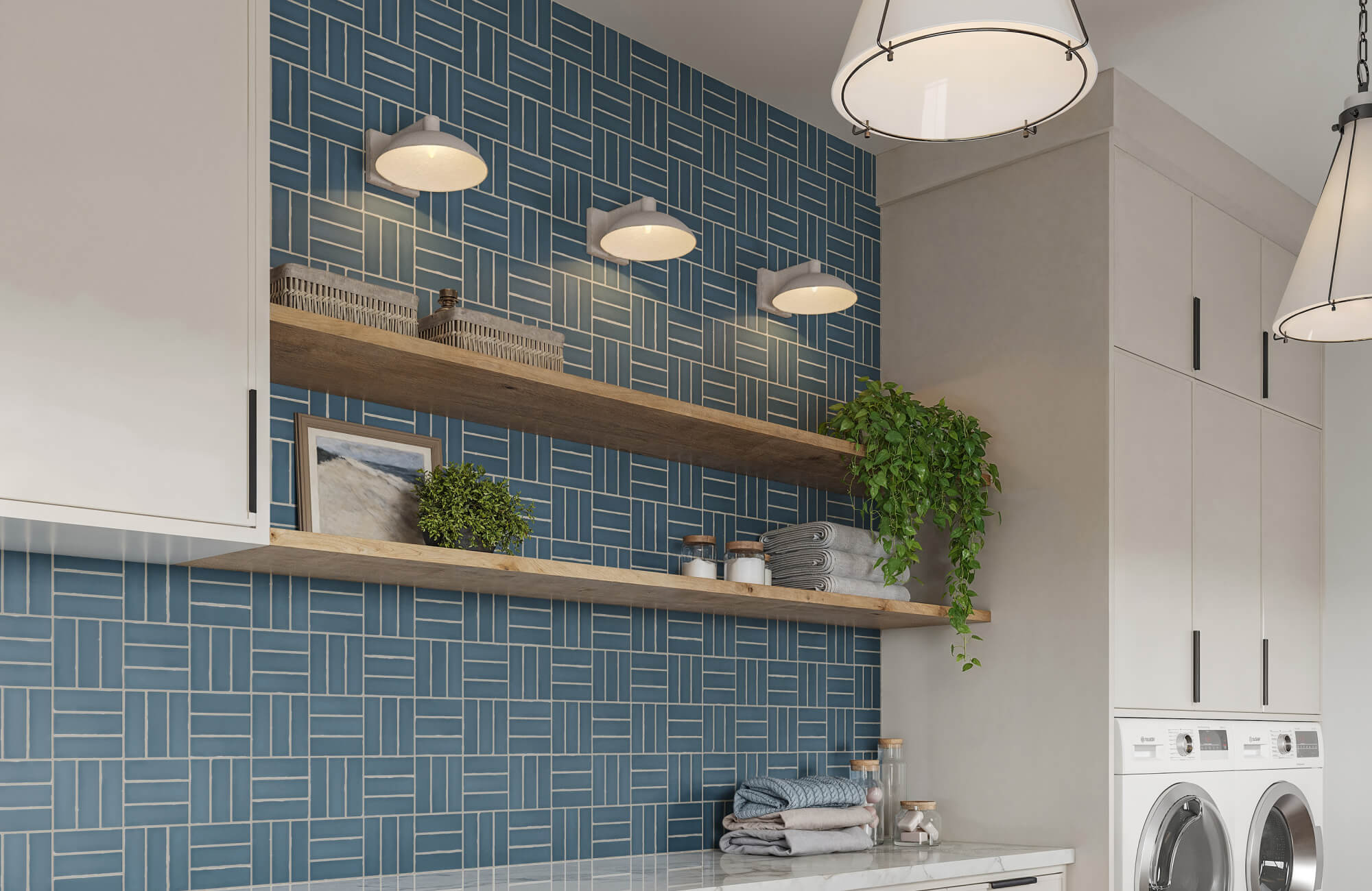 Contemporary laundry room with geometric blue tile backsplash, accented by matte white wall sconces and cone pendant lights that add layered illumination and modern warmth to the space.