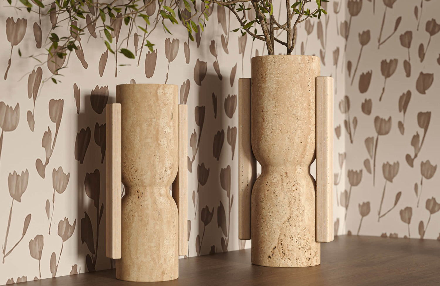 Tall beige decorative vases with carved stone surfaces and wood details are placed on a wood console, set against a soft, floral-patterned wall.
