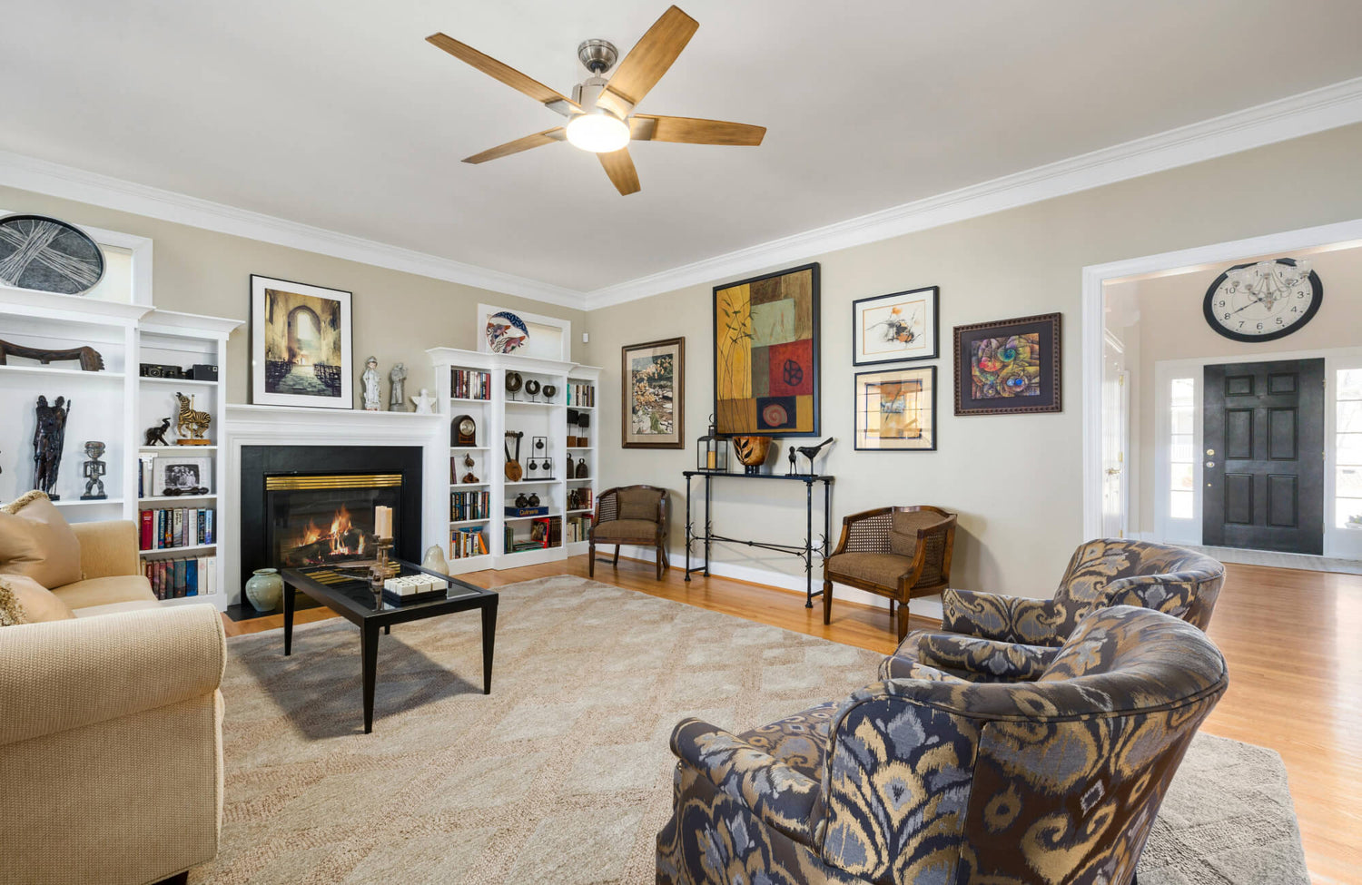 Living room with a gallery wall arrangement featuring varied frame sizes and artwork styles, demonstrating how to combine multiple pieces for a cohesive and balanced display